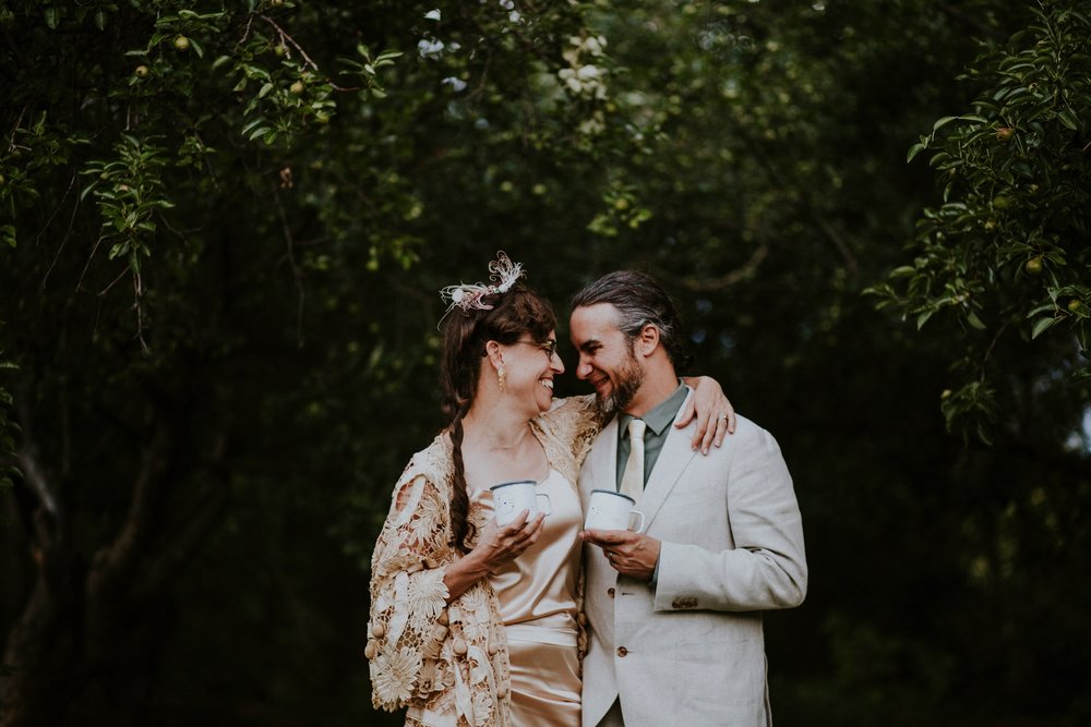  The dress theme for the whole wedding celebration was rainbows - their guests dressed in one color head to toe as part of the theme. The wedding reception at the ranch was near the orchard by the acequia, and was lit by candles and solar lights prim