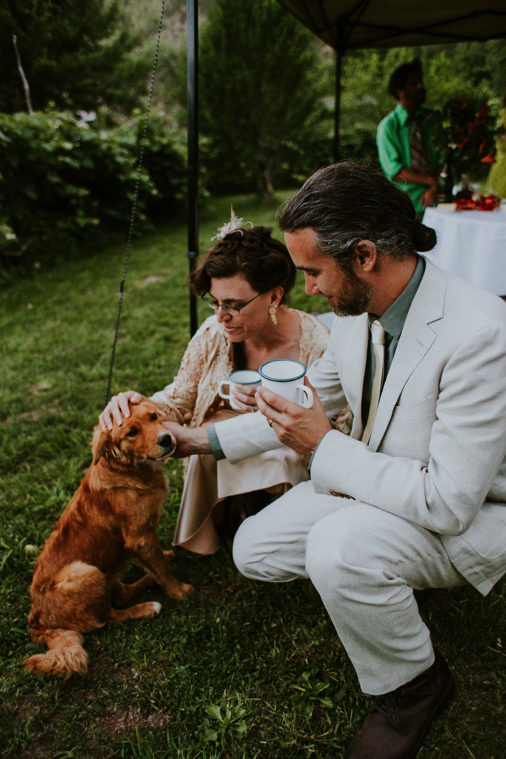  The dress theme for the whole wedding celebration was rainbows - their guests dressed in one color head to toe as part of the theme. The wedding reception at the ranch was near the orchard by the acequia, and was lit by candles and solar lights prim