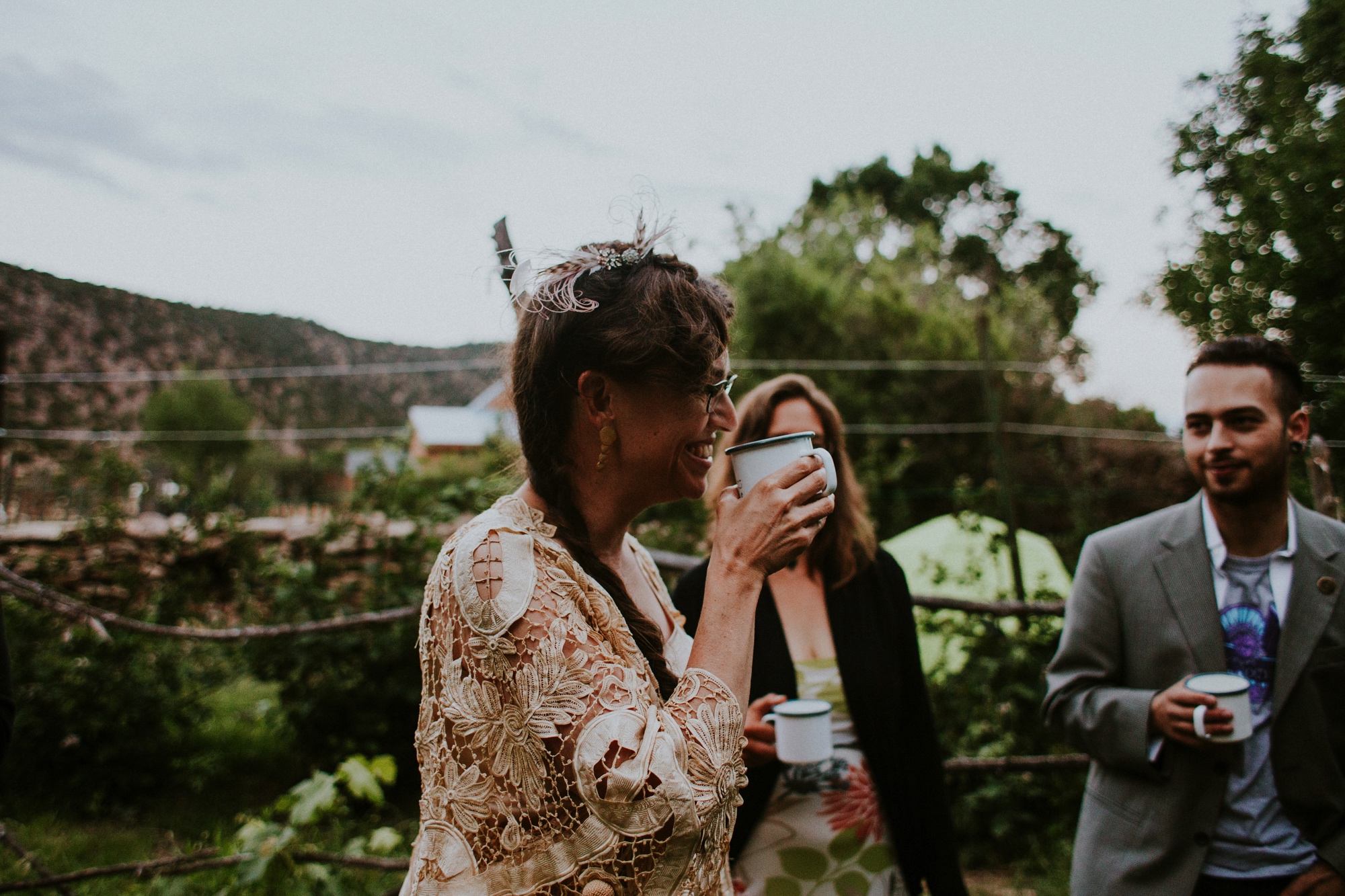  The dress theme for the whole wedding celebration was rainbows - their guests dressed in one color head to toe as part of the theme. The wedding reception at the ranch was near the orchard by the acequia, and was lit by candles and solar lights prim