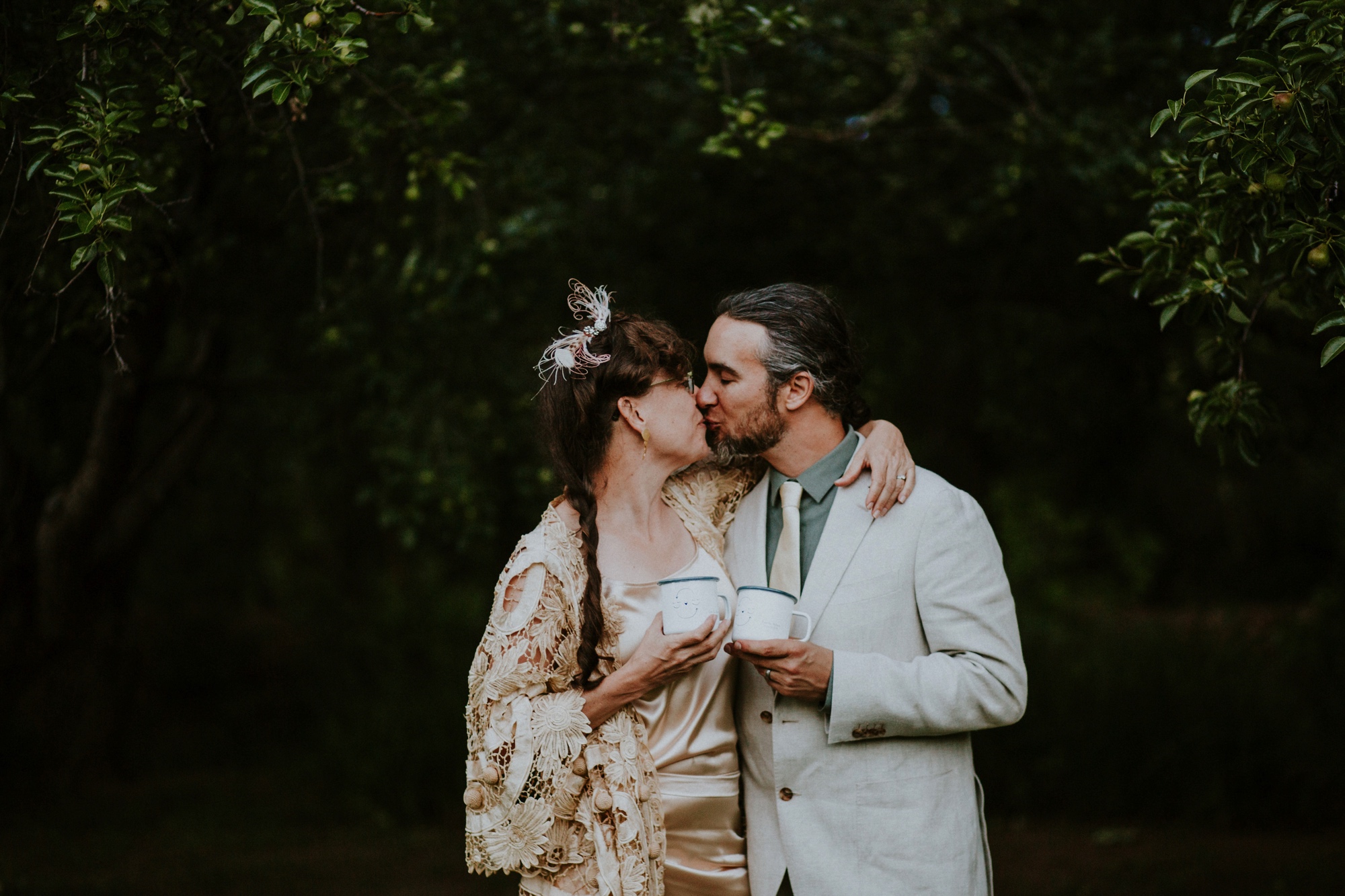  The dress theme for the whole wedding celebration was rainbows - their guests dressed in one color head to toe as part of the theme. The wedding reception at the ranch was near the orchard by the acequia, and was lit by candles and solar lights prim