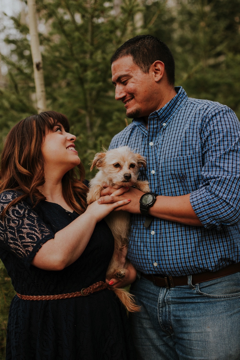  Suzie and Cruz chose the perfect fall engagement outfits for their Santa Fe engagement photos. You can never go wrong with cute brown boots and a blue lace dress! Cruz completed the rustic engagement look with a blue checkered button up and jeans. I