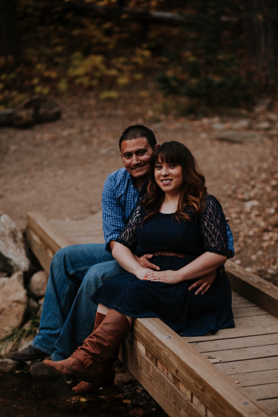  Suzie and Cruz chose the perfect fall engagement outfits for their Santa Fe engagement photos. You can never go wrong with cute brown boots and a blue lace dress! Cruz completed the rustic engagement look with a blue checkered button up and jeans. I