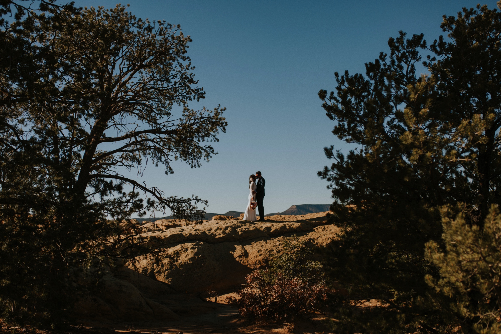  Jade and Alex eloped at the amazing and scenic El Malpais National Monument outside of Grants, New Mexico. It was a beautiful November day and the weather was crisp, fresh, and just a tad chilly, but it didn’t get in the way of their fabulous weddin