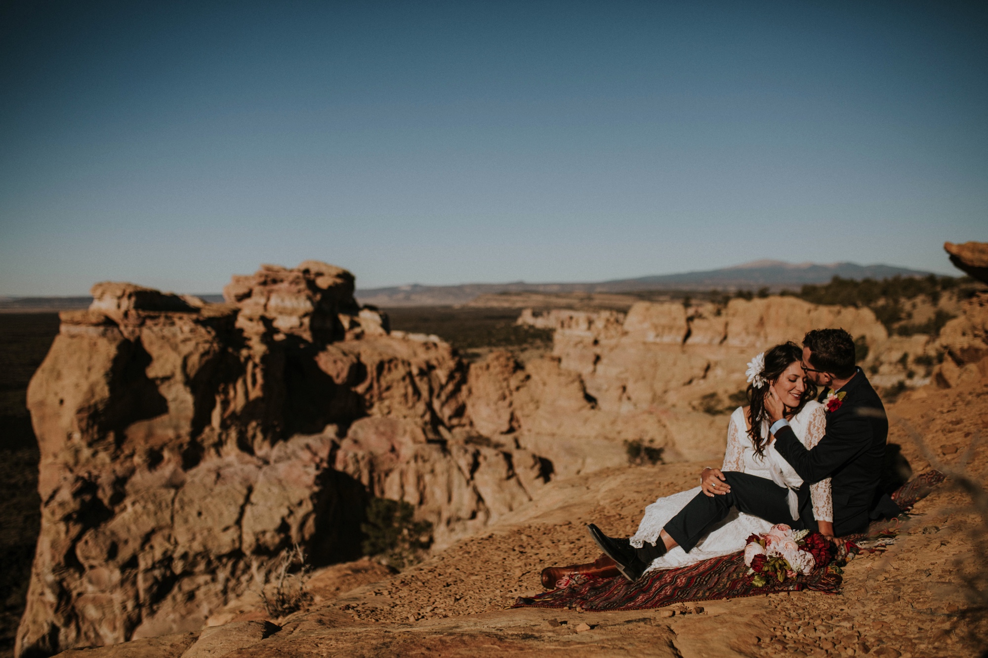  Jade and Alex eloped at the amazing and scenic El Malpais National Monument outside of Grants, New Mexico. It was a beautiful November day and the weather was crisp, fresh, and just a tad chilly, but it didn’t get in the way of their fabulous weddin