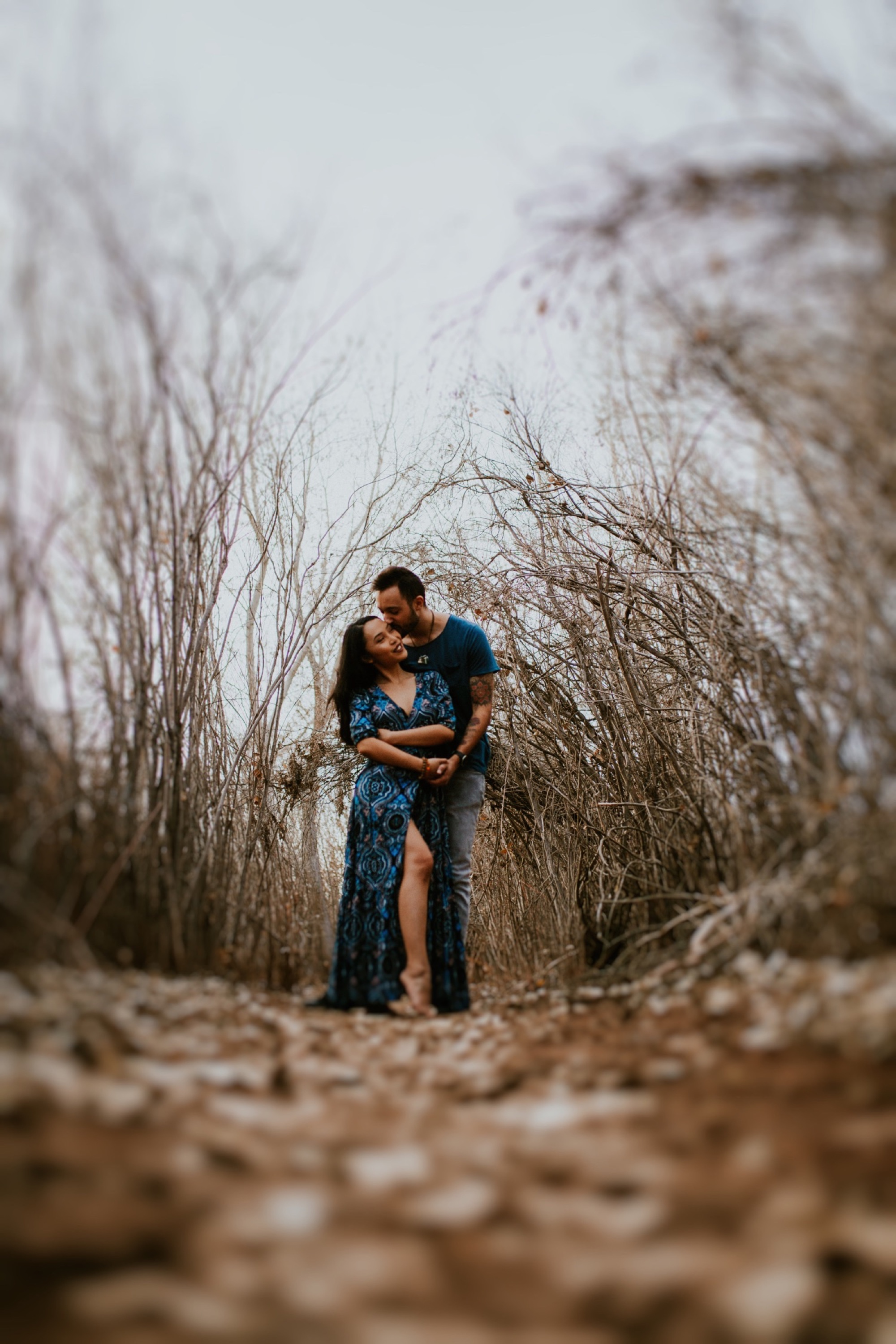  I loved working with Xamie and Nate on this incredible couples portrait session at the Alameda Bosque Open Space in Albuquerque, New Mexico. Our session started off with grey overcast skies that made for some moody portraits! Xamie’s blue dress and 