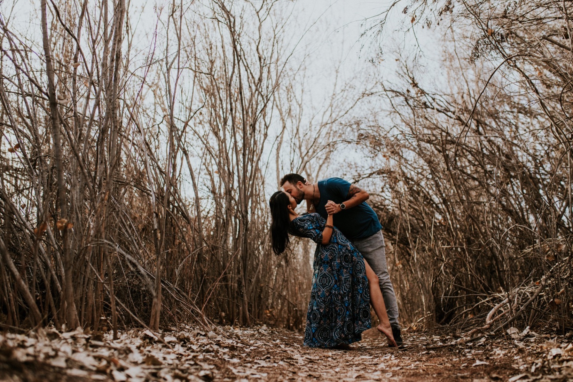  I loved working with Xamie and Nate on this incredible couples portrait session at the Alameda Bosque Open Space in Albuquerque, New Mexico. Our session started off with grey overcast skies that made for some moody portraits! Xamie’s blue dress and 