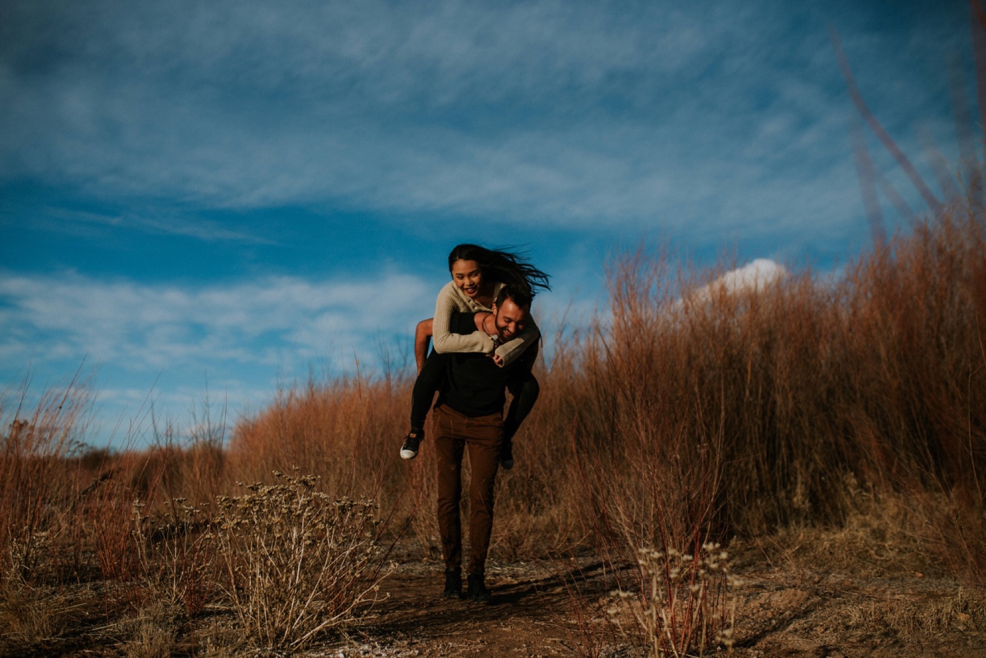  I loved working with Xamie and Nate on this incredible couples portrait session at the Alameda Bosque Open Space in Albuquerque, New Mexico. Our session started off with grey overcast skies that made for some moody portraits! Xamie and Nate’s outfit