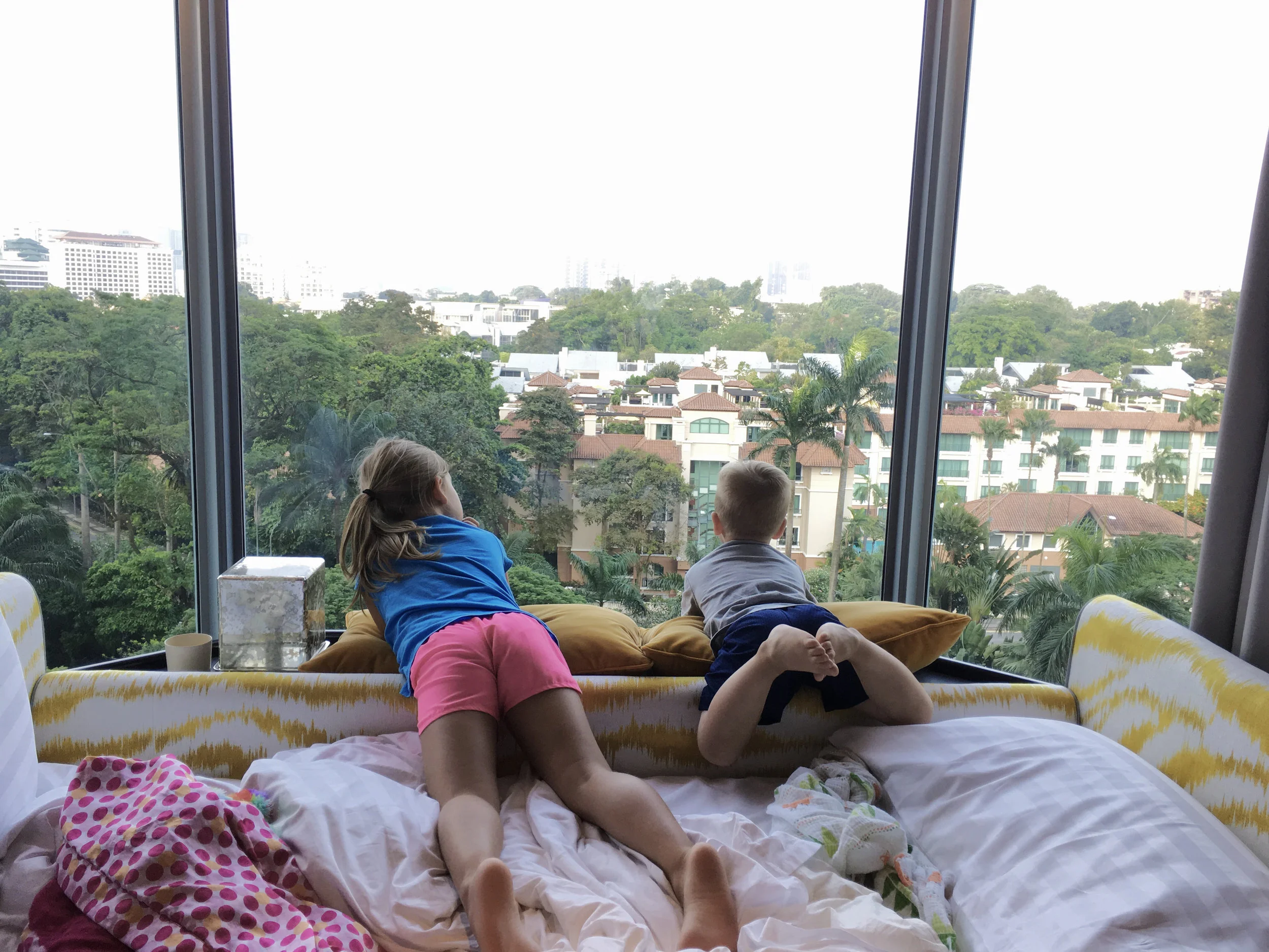 The kiddos are looking out the hotel window at the view!