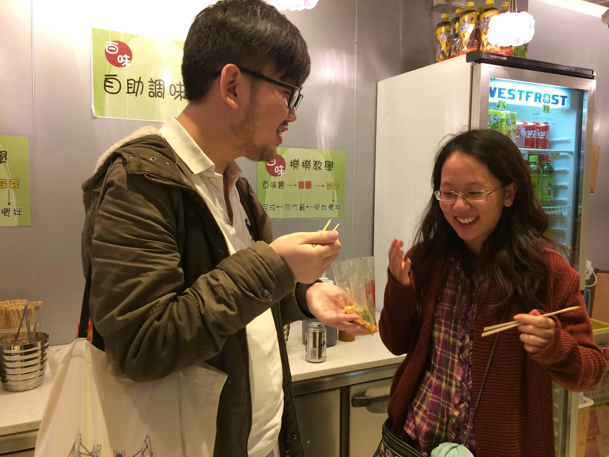 Xavier and Apple eating noodles from a bag