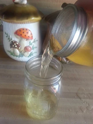 Strain that fermented goodness. Try not to spill!