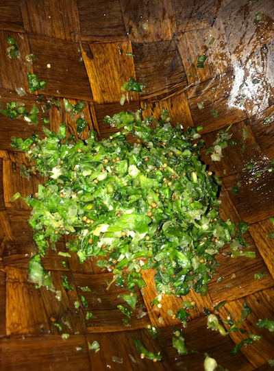 Roughly chopped Sofrito consisting of recao, aji dulce, garlic, onion, African oregano, and coriander.