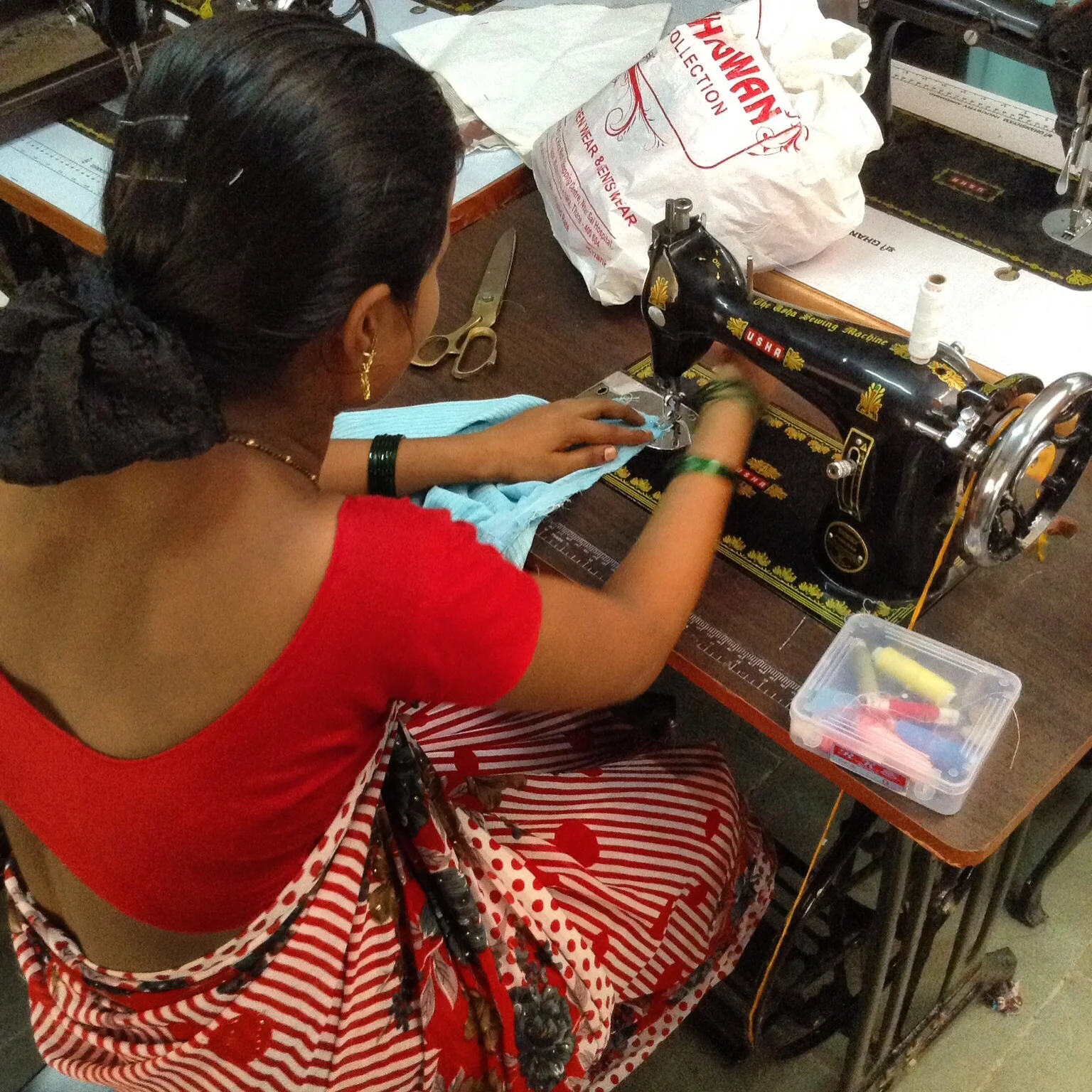 A young woman involved in CORP's educational program refines her sewing skills.