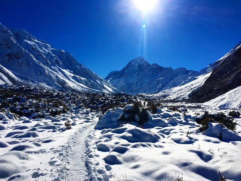 Sir Edmond Hillary prepared to summit Mt. Everest on the peak in front of me in this picture, underneath the sun's rays (Aoraki/Mount Cook). (PC: Ehole)