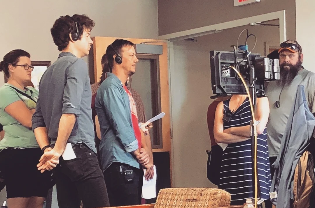 Me on set, headphones on, watching and listening.