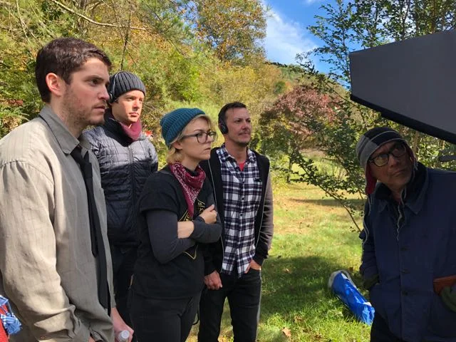 Watching the scene unfold on the monitor.