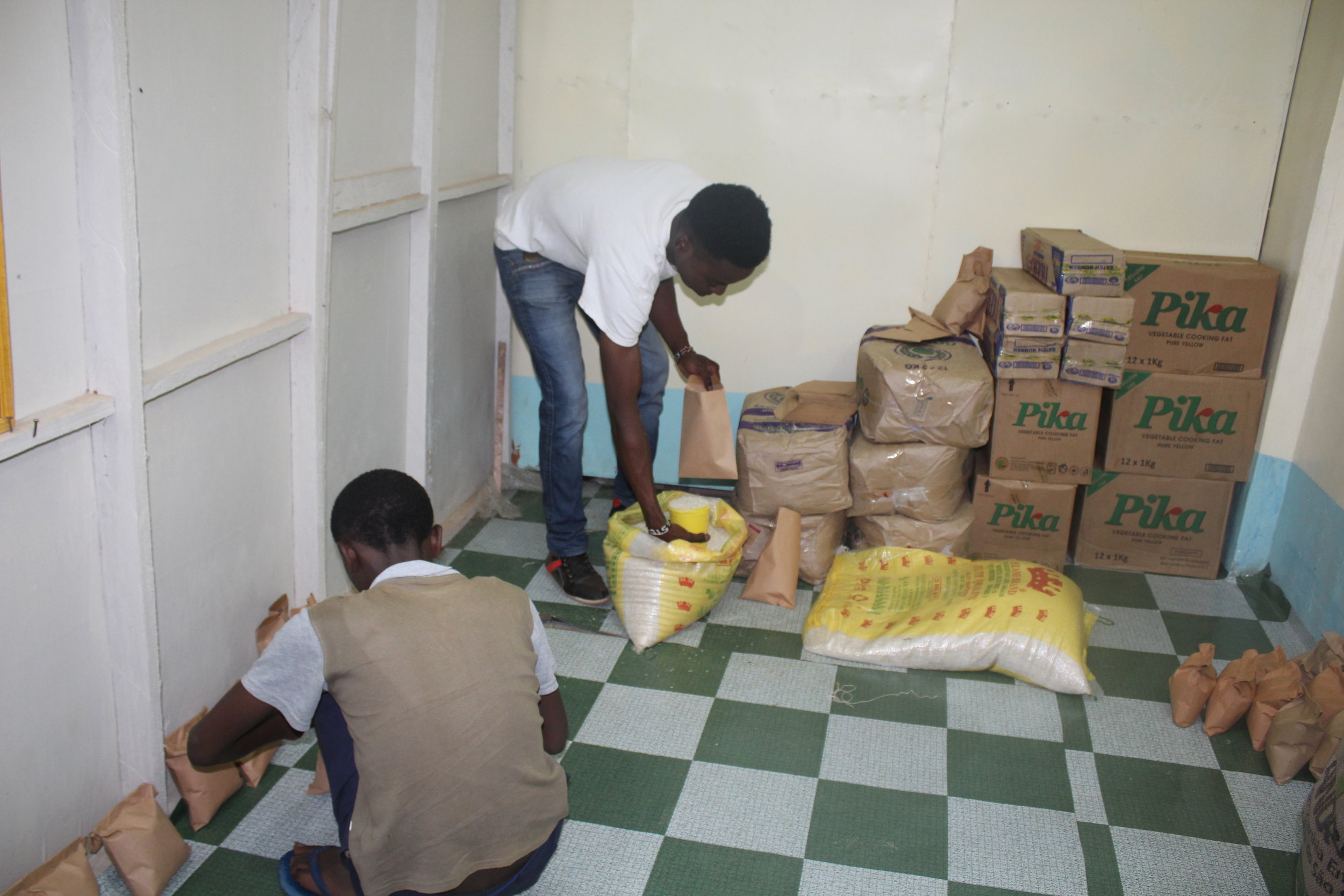  The sponsored kids helped organize and distribute food for village households caring for orphans. 