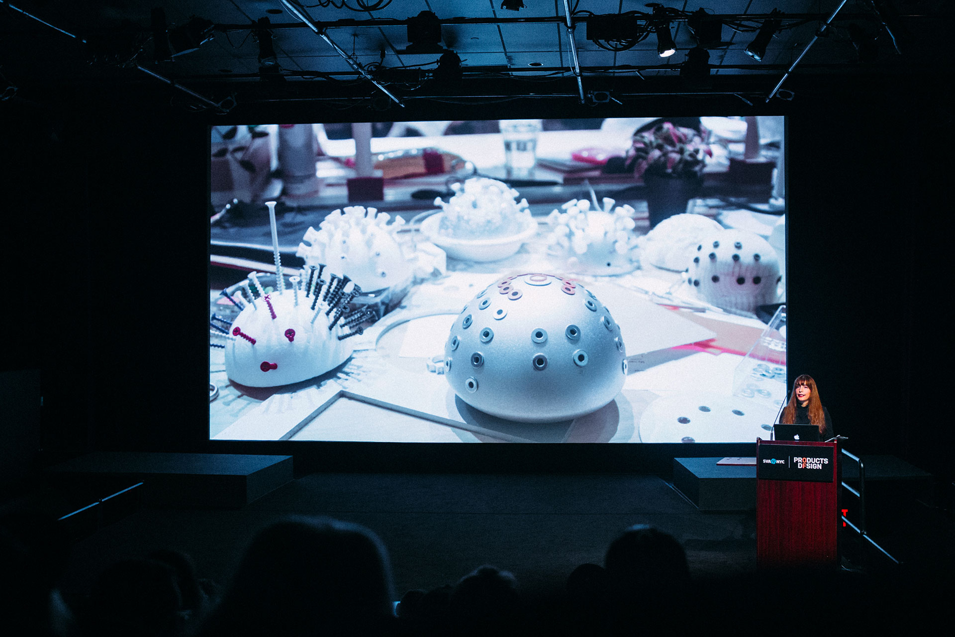  Speaker at the podium with image of products on screen 