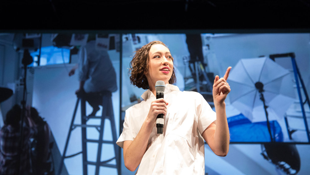 Student presenting work on stage with microphone (Copy)