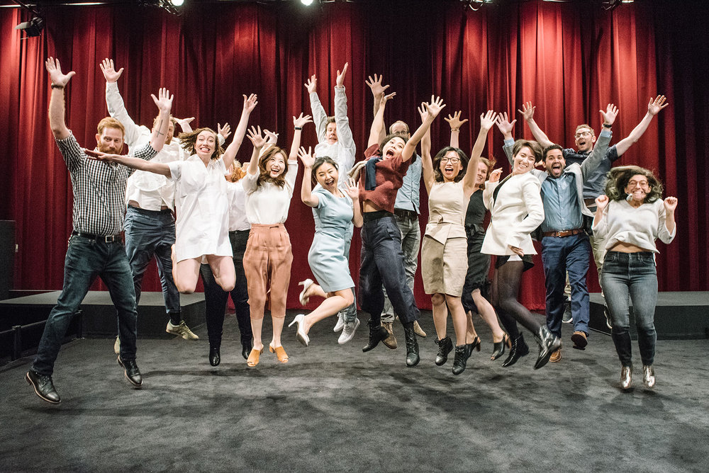 Group of students jumping on stage together (Copy)