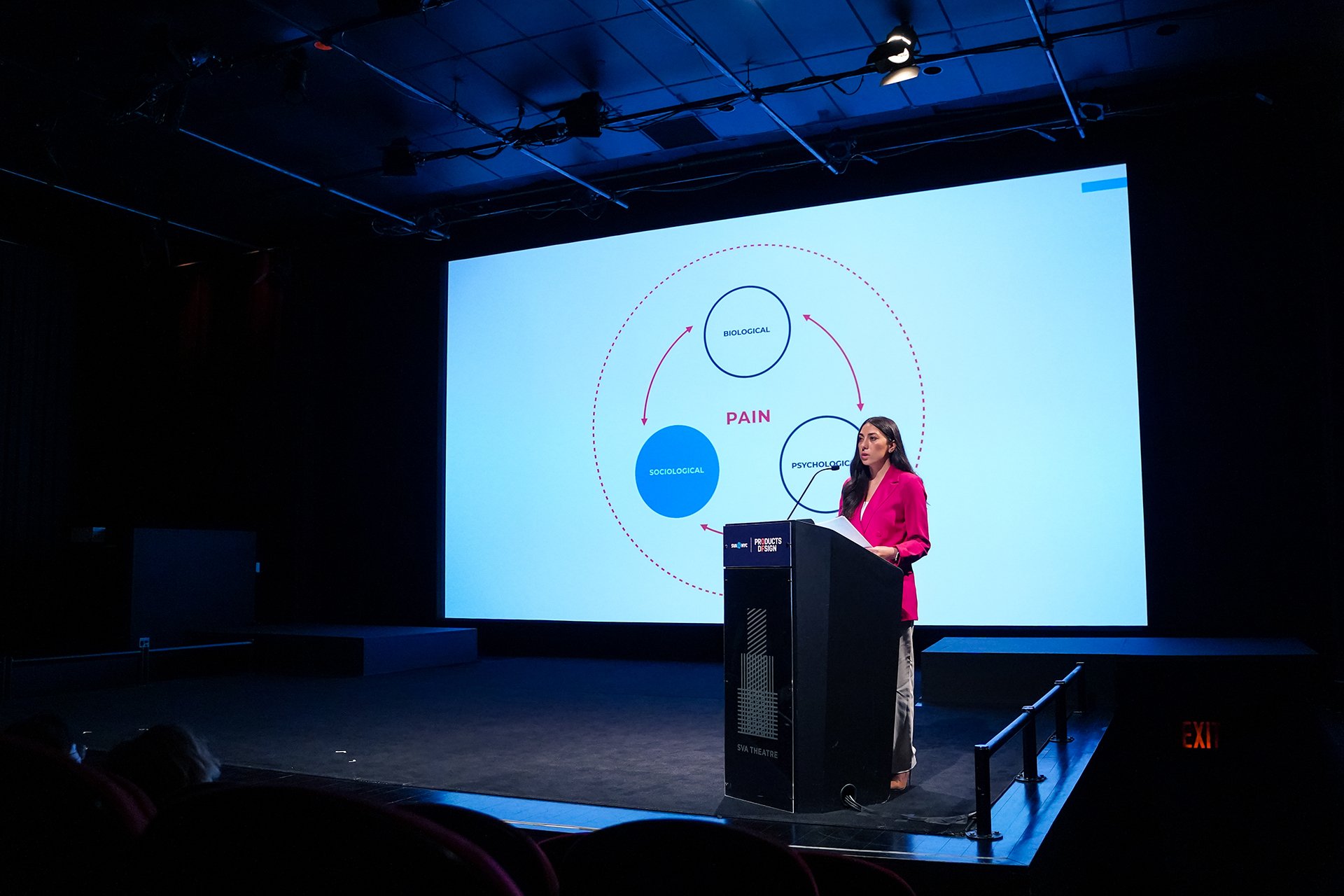  Danna Krouham speaking at the podium at the SVA theatre 