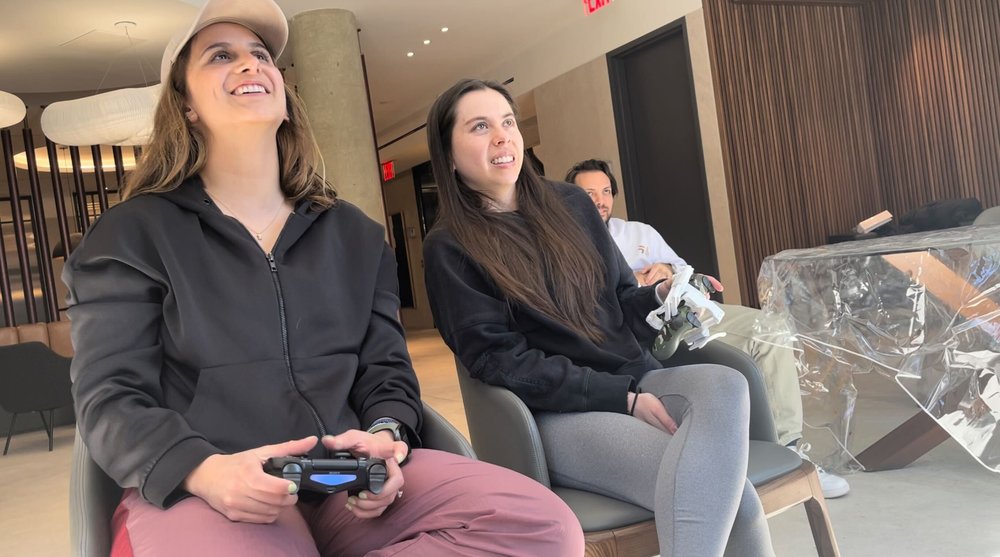  Image of group of three people playing a video game 