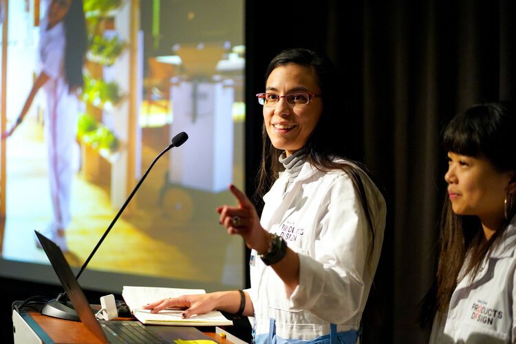  Image of student at the podium and pointing to the audience 