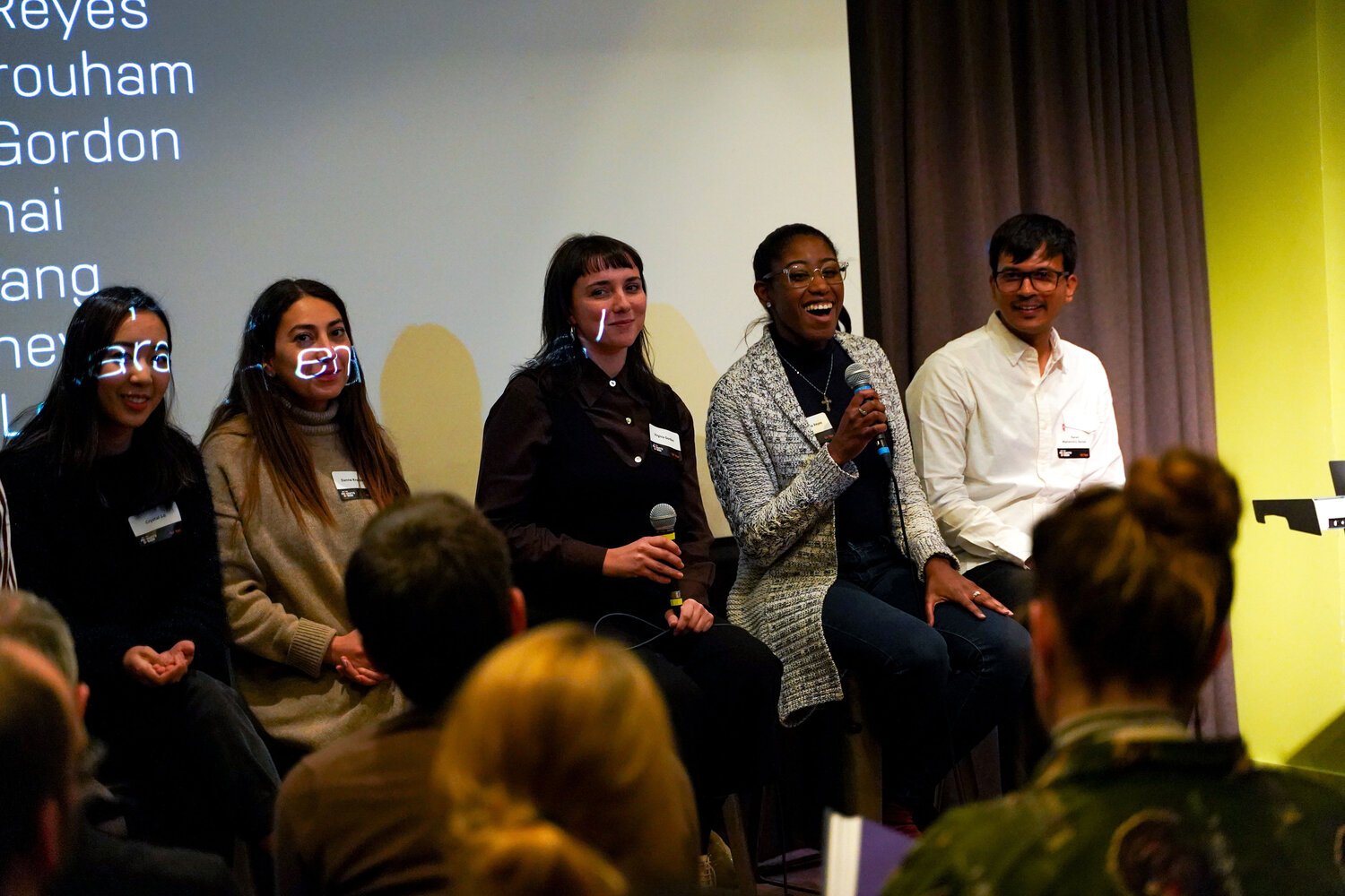  5 students and alumni are speaking during a panel discussion  