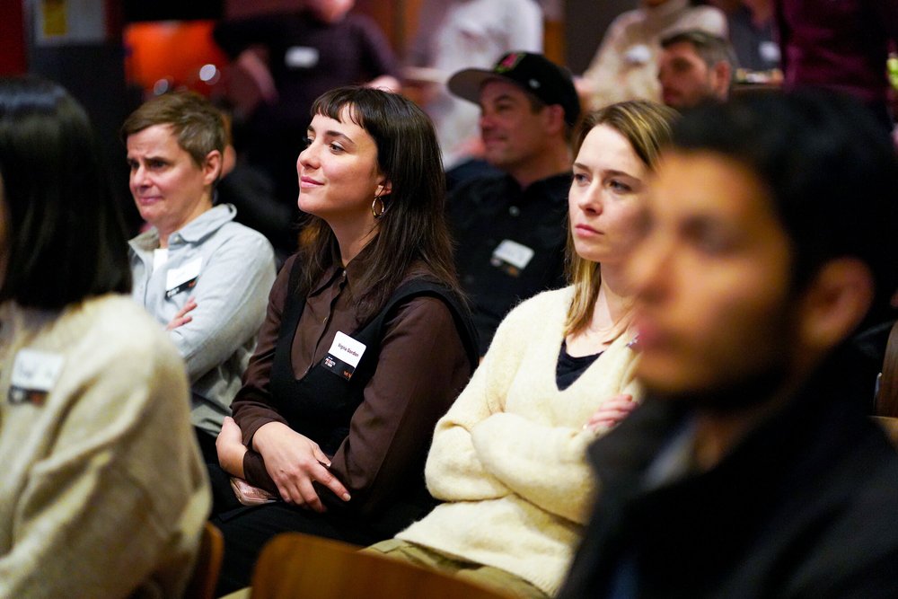  A crowd of prospective students are listening in the audience  