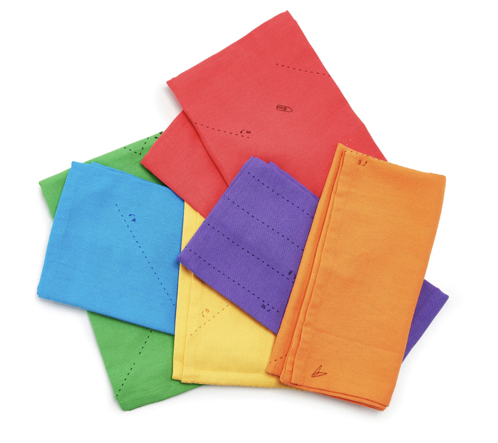  Stack of cloth napkins in yellow, orange, purple, blue, green and red. 