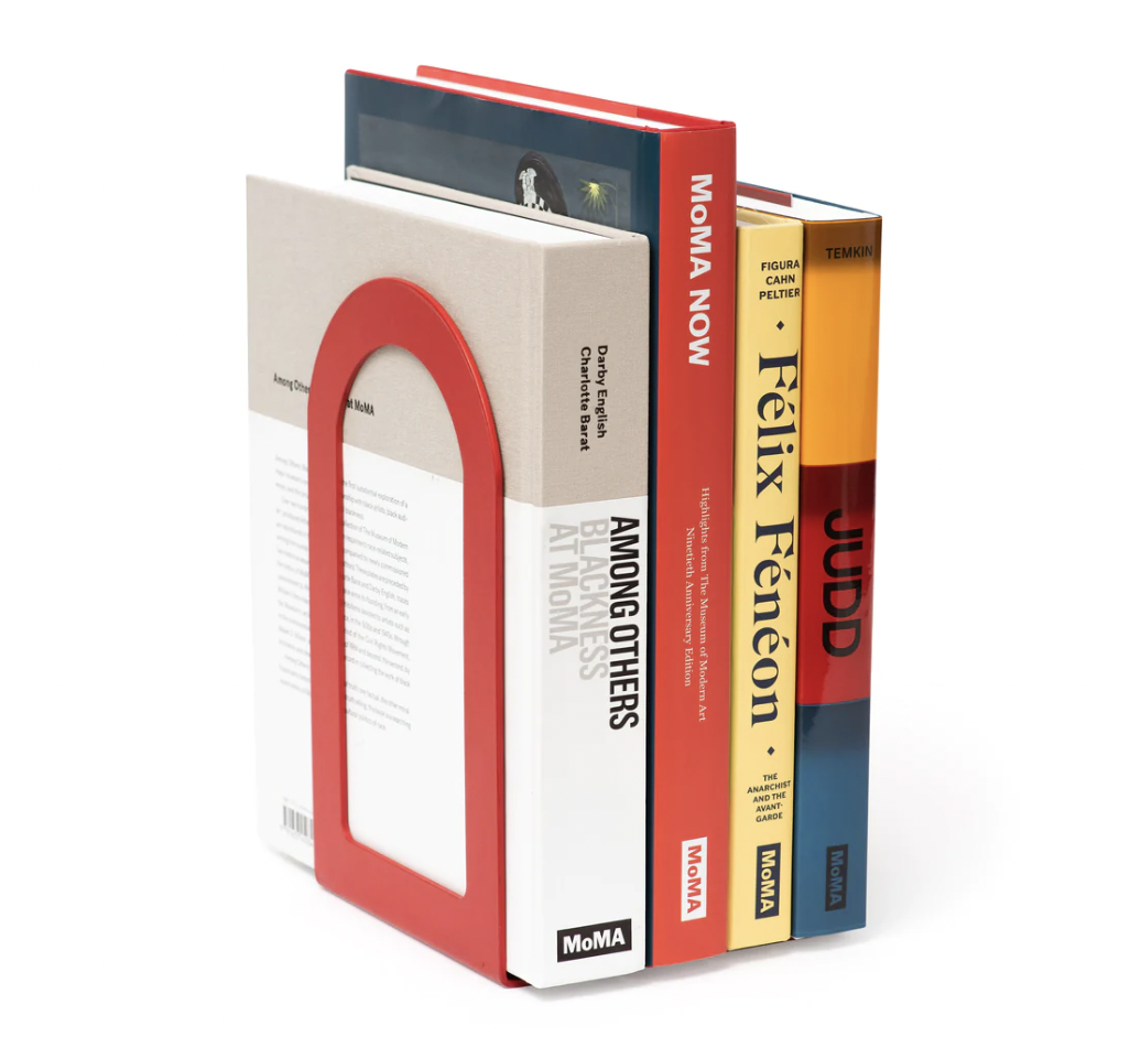  One red  Fenestra Bookends  holding up a stack of books. 