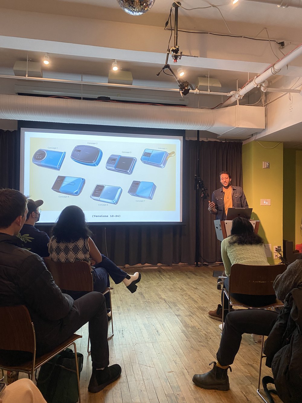  Speaker Souvik Paul giving a lecture at the Products of Design department; the image shows students in the audience and Souvik Paul at the podium with a slide of his work projected on the screen 