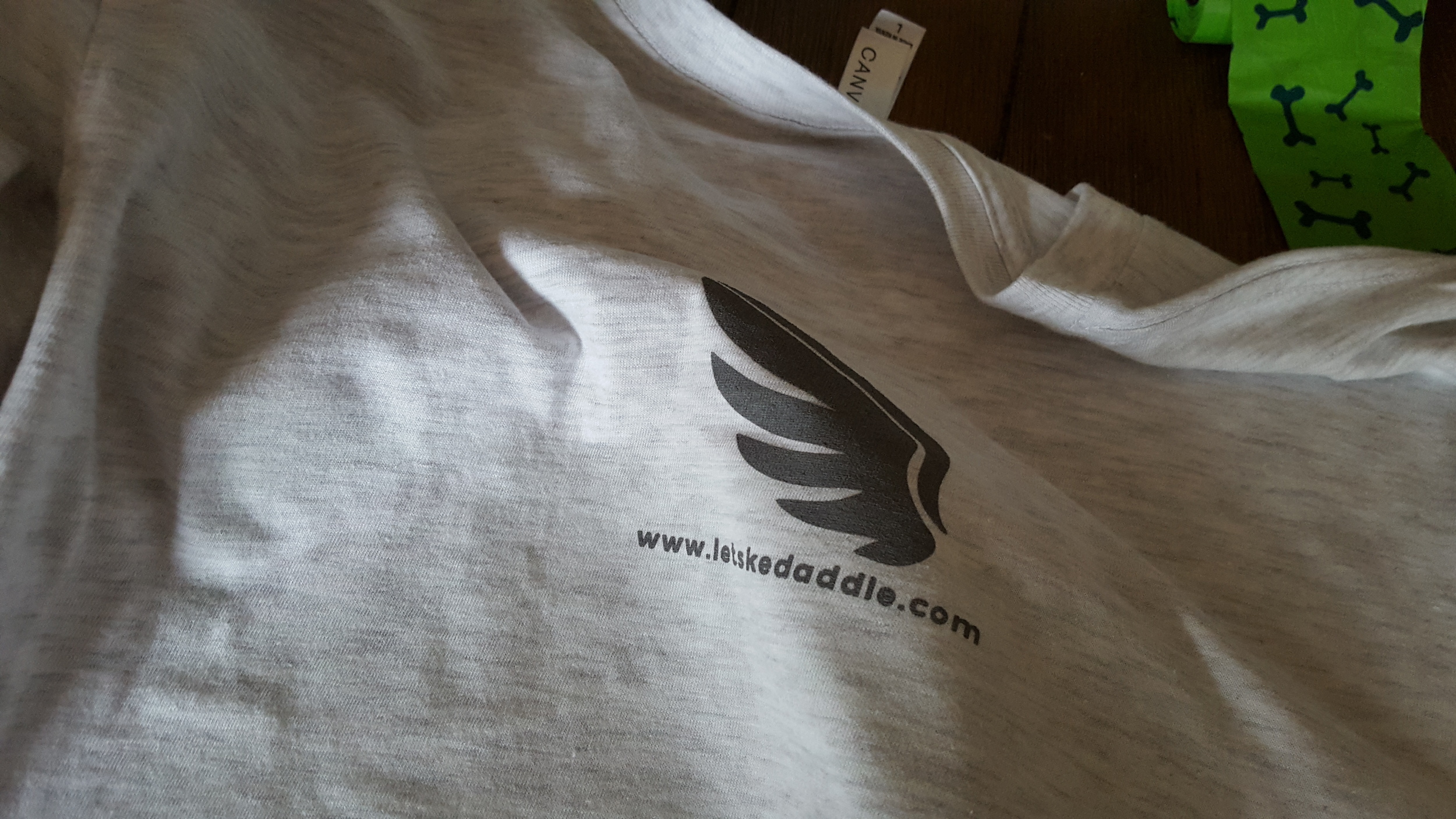 Top back of the shirt has this small 4"x4" logo with the url. 