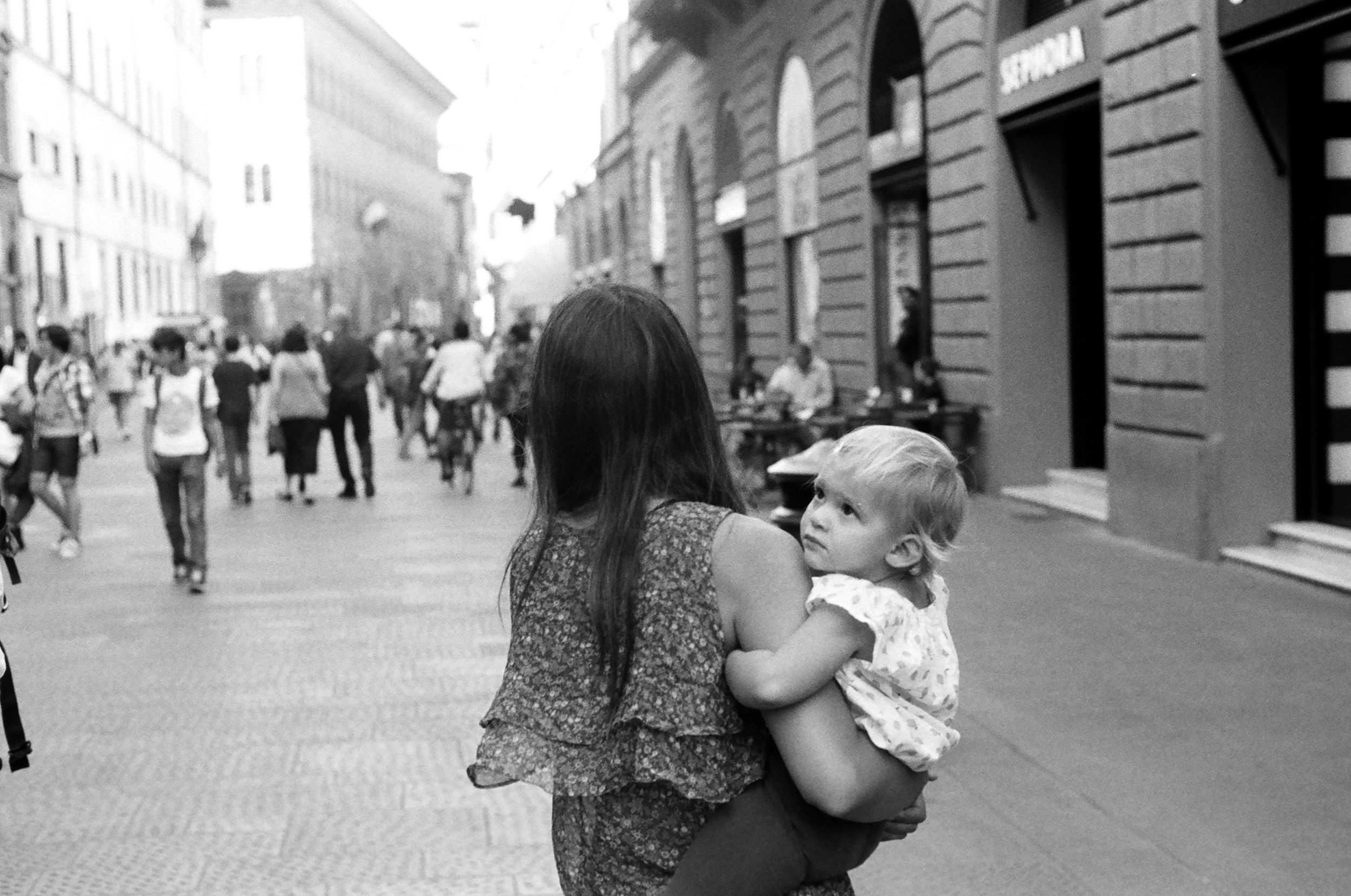 A baby and her mom doing some afternoon shopping