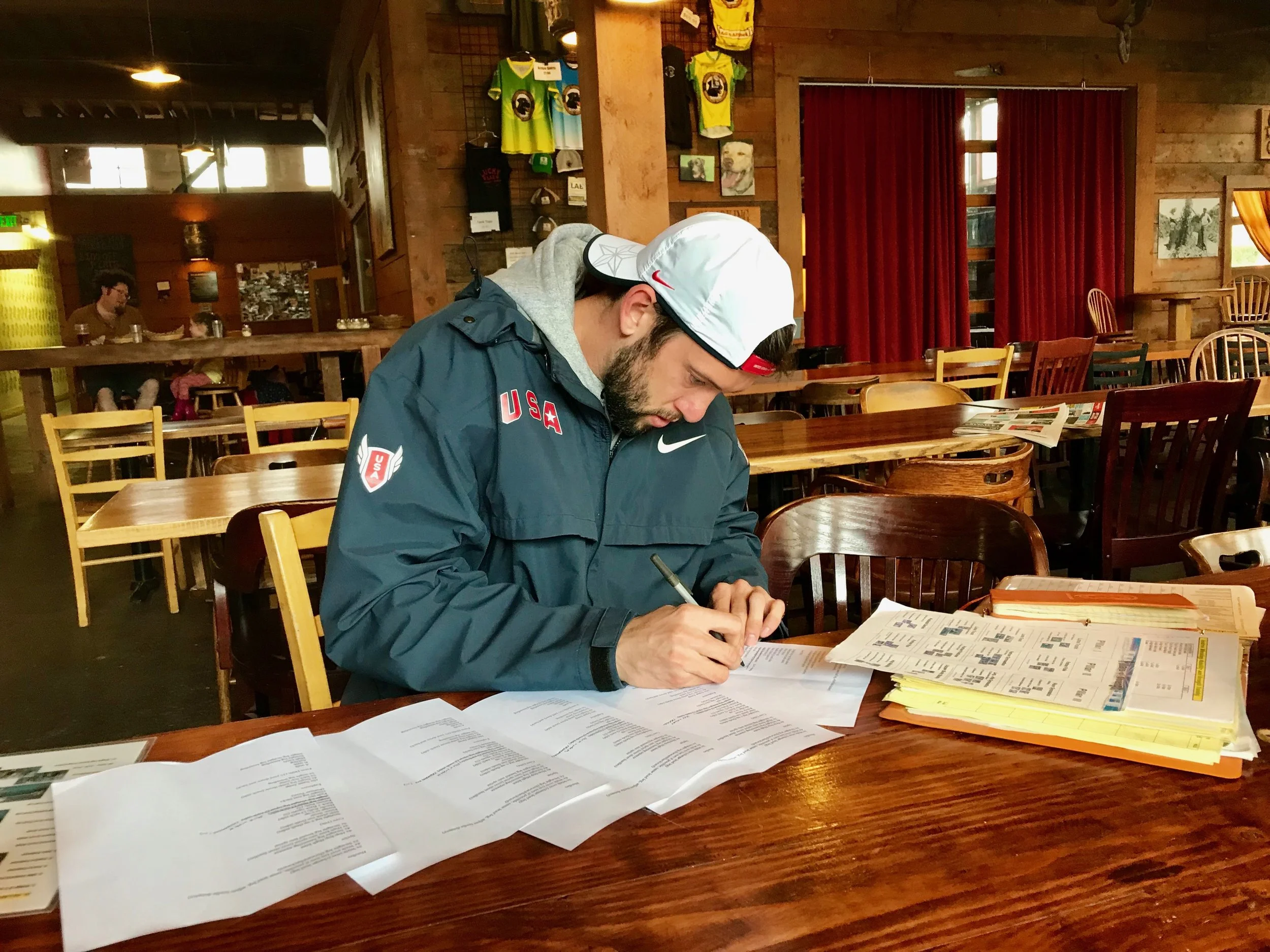 Coach Andrew Wheating, meticulously readying training plans for his athletes.