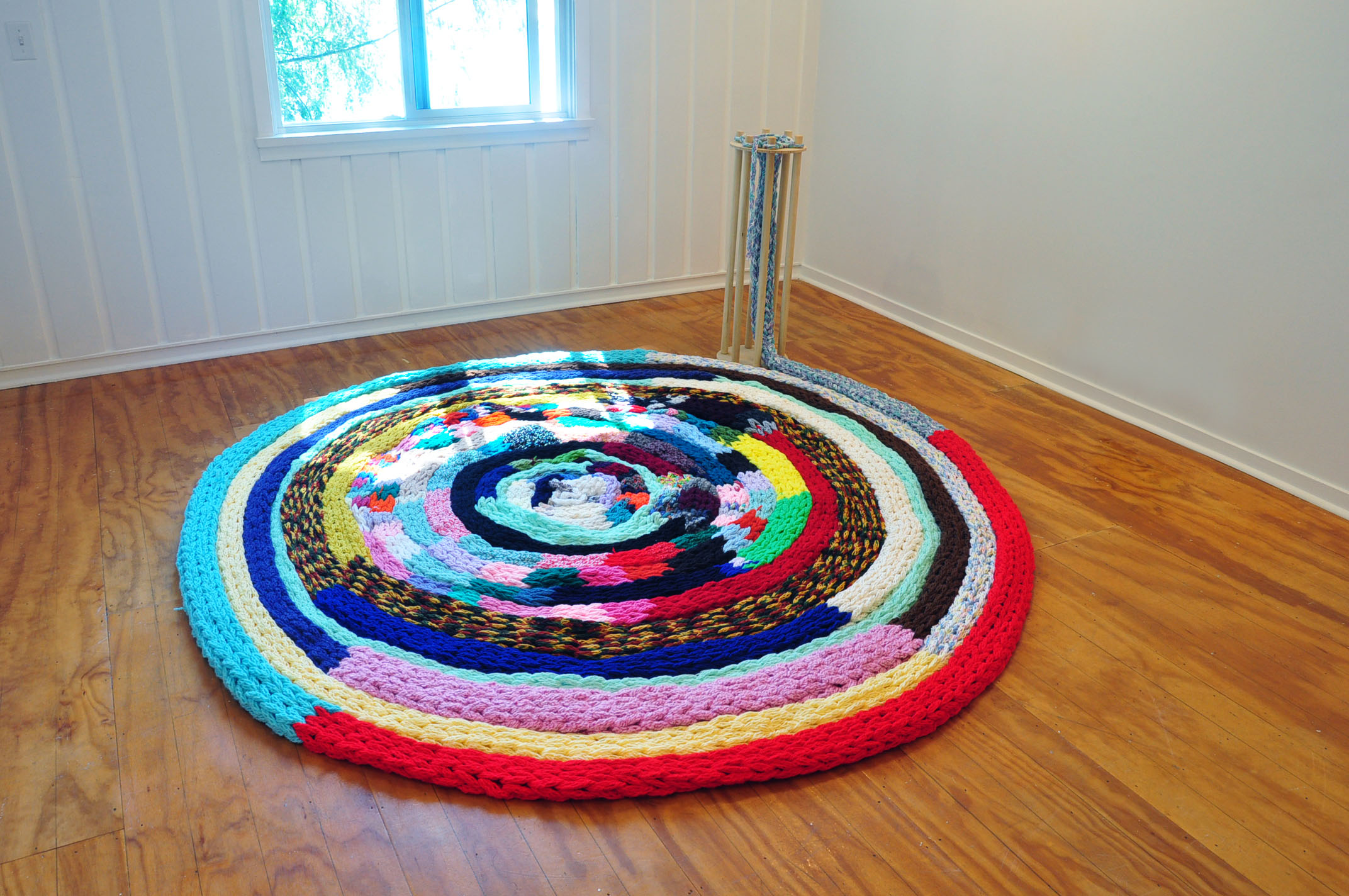   The Machine: Knitting Ouroboros , 2019, yarn, wood, approx. 10ft Wide in Diameter 