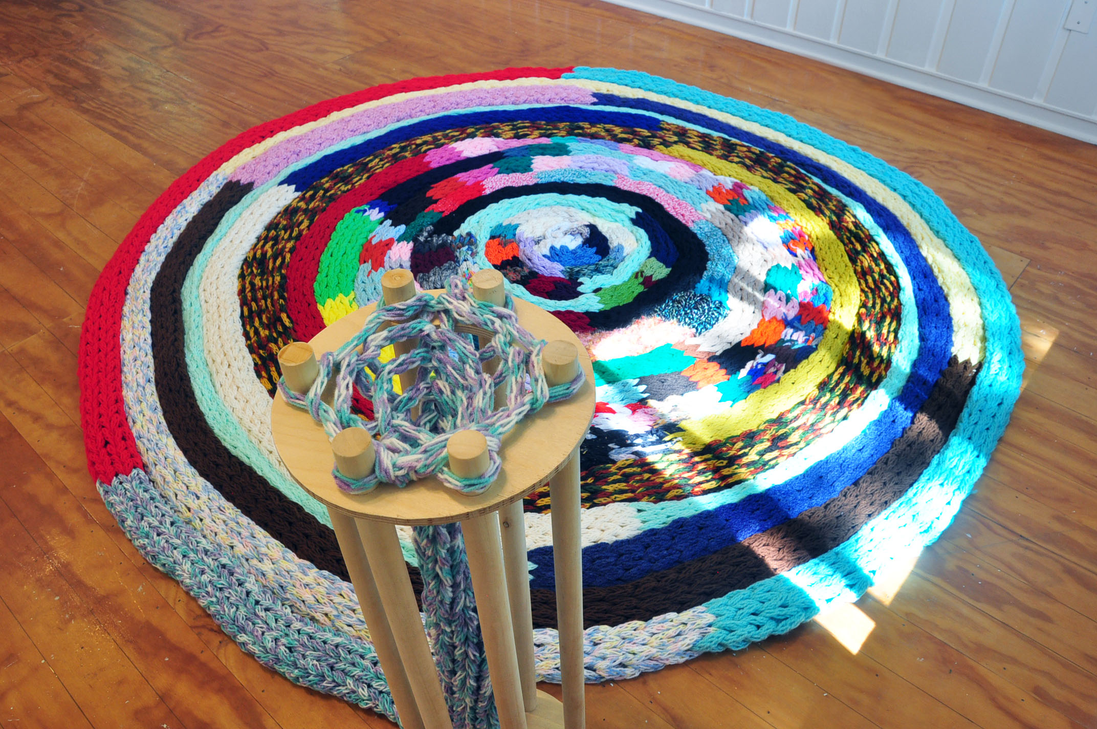   The Machine: Knitting Ouroboros , 2019, yarn, wood, approx. 10ft Wide in Diameter 