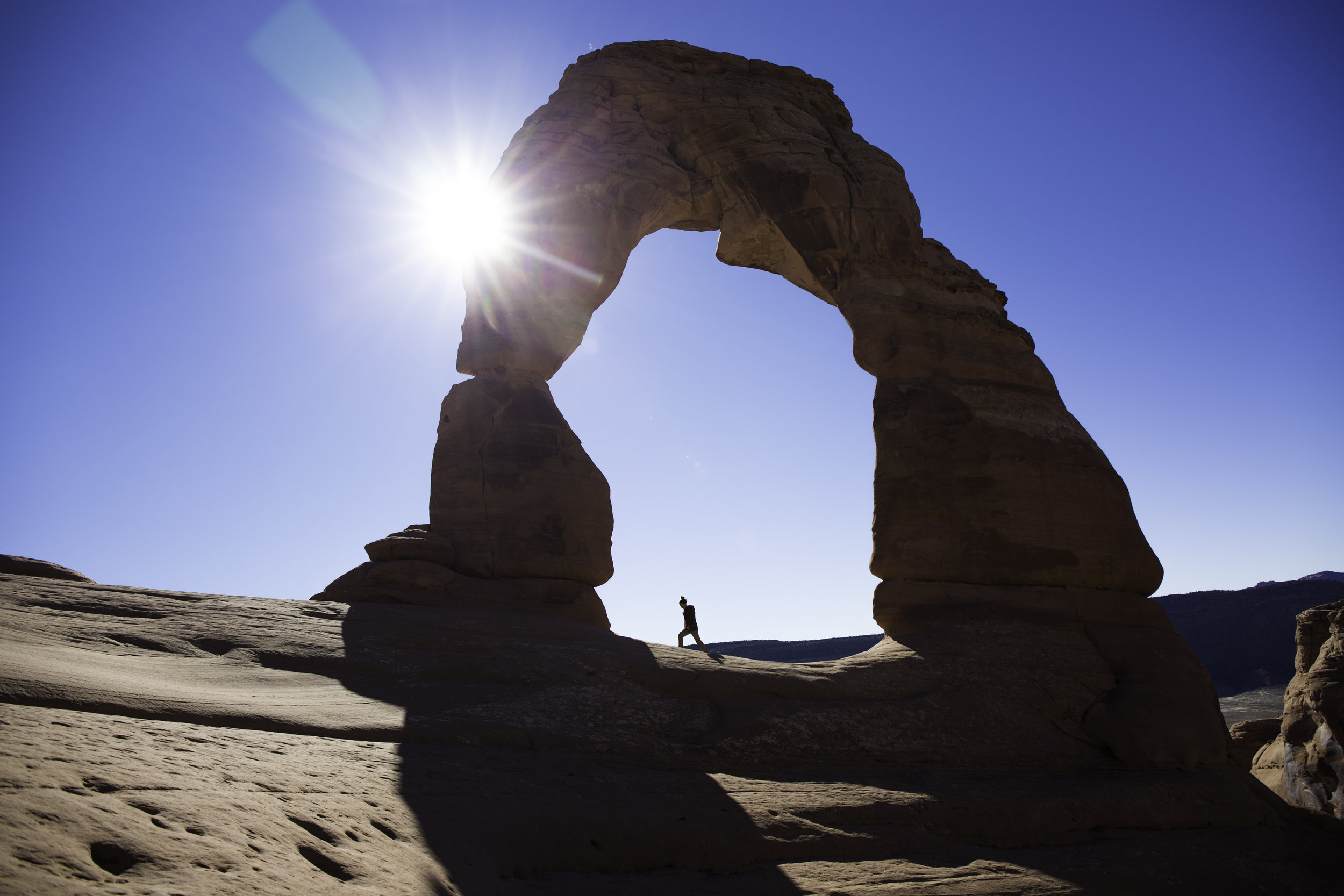 Kayla walking below Delicate Arch