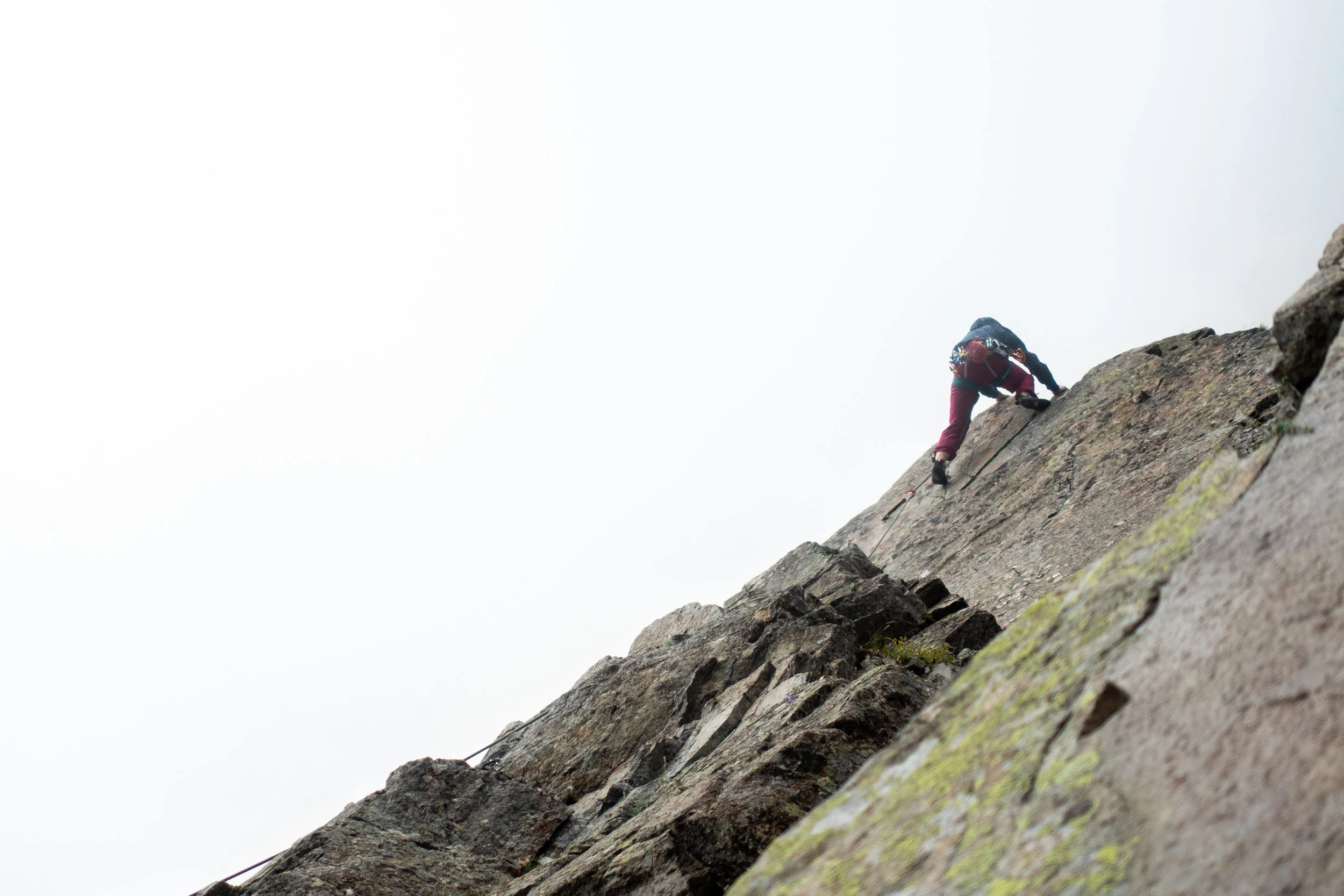 In the clouds, Natalie takes one of the cruxes down.