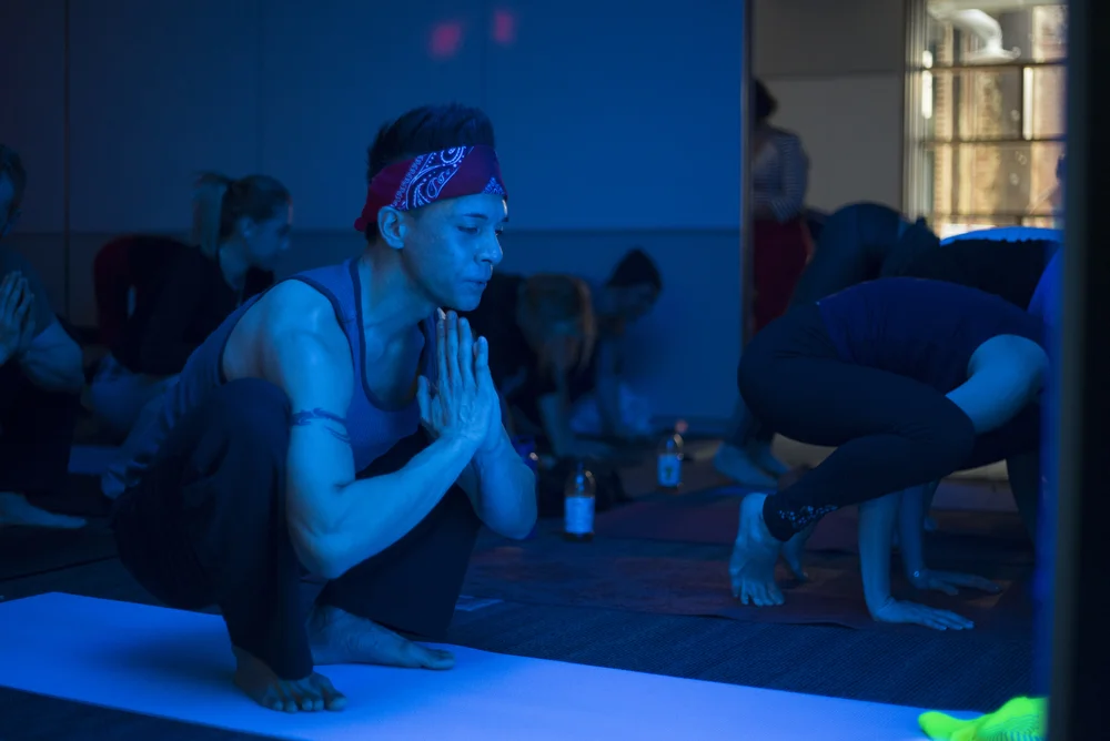 Grip The Mat team member Alden getting low in malasana.