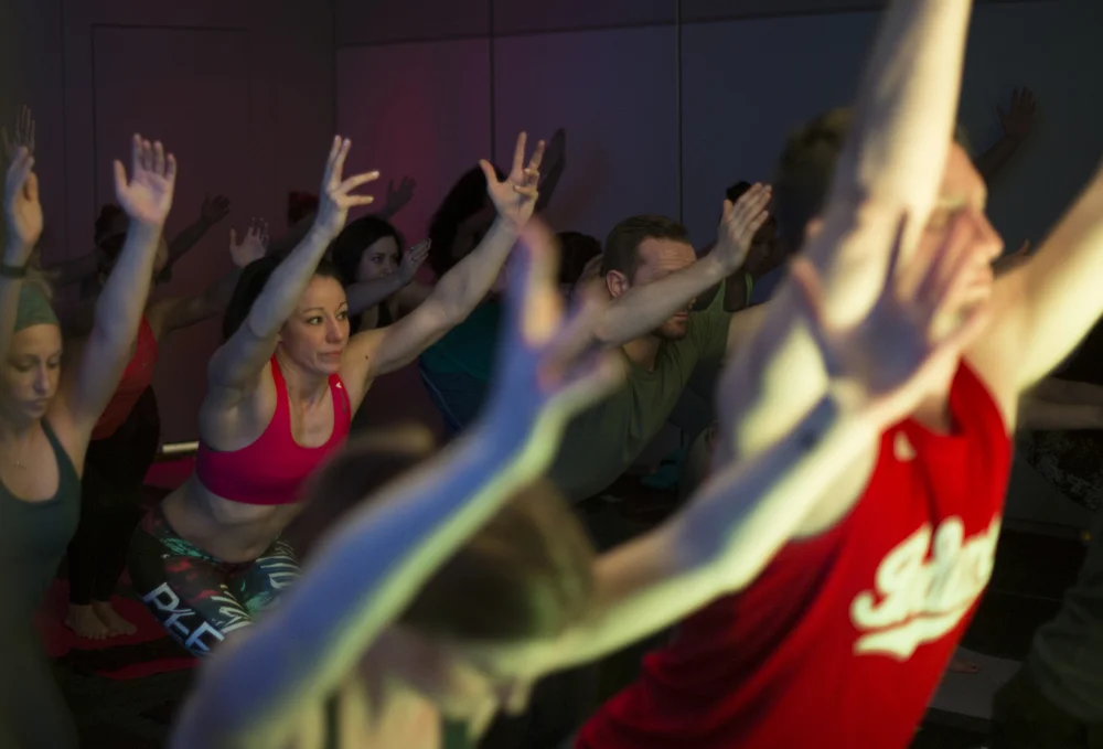 Reebok Fithub's Andrea Ferry sinking into a deep chair pose as the class flows through Sun Salutation B