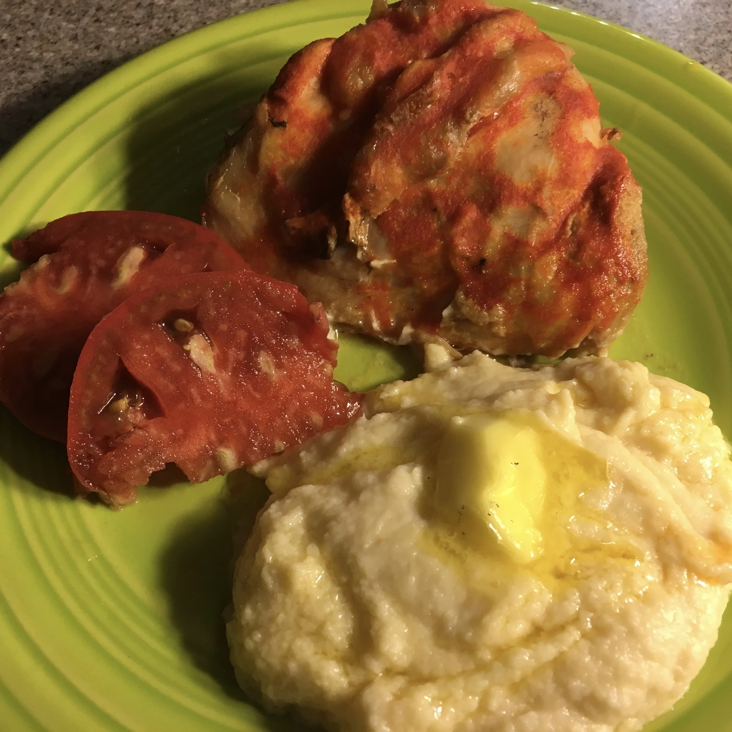 Barely a carbohydrate in sight and so yummy. (Skin on chicken thigh cooked in coconut oil, covered in Franks' Hot Sauce, home grown tomato, and mashed cauliflower with butter.)