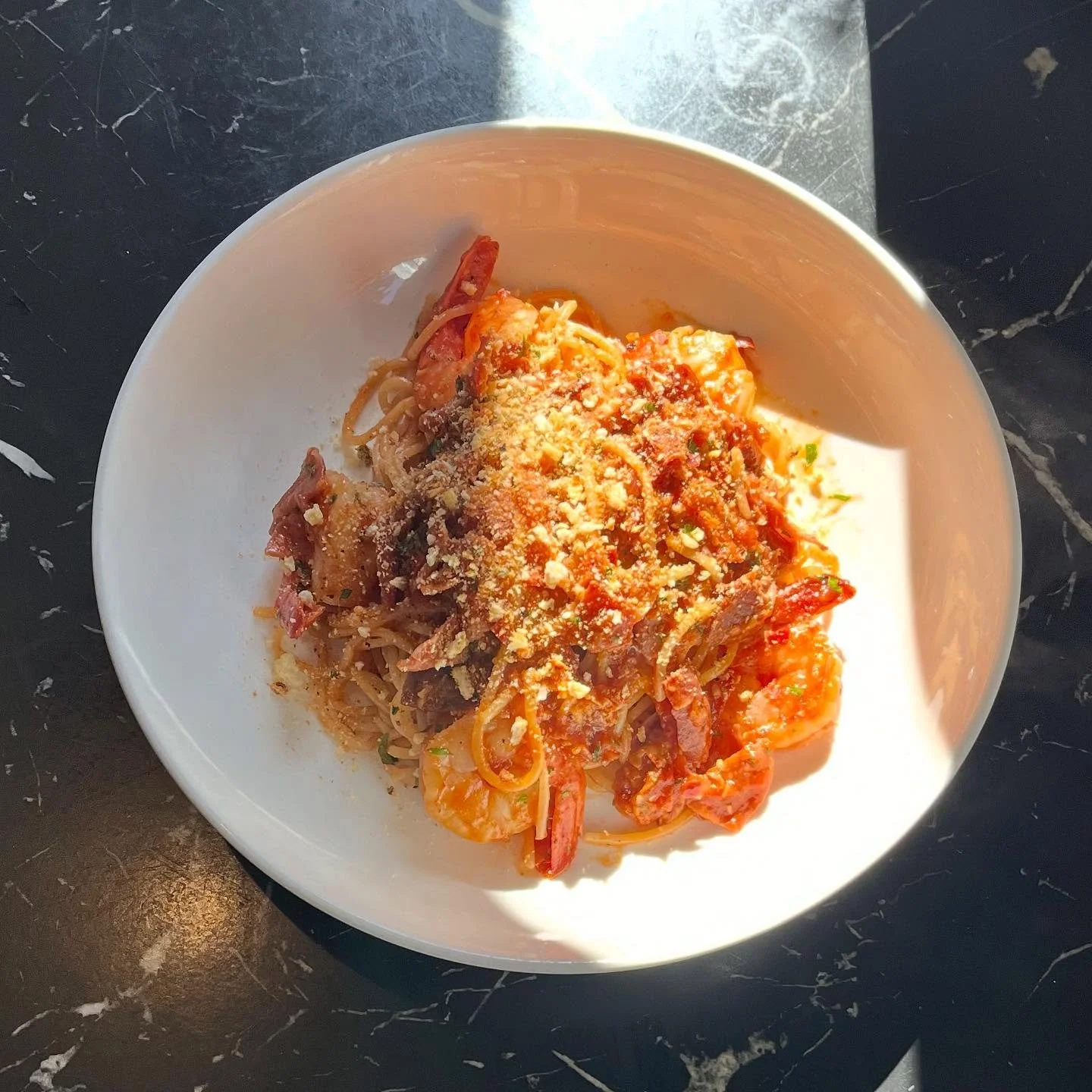 Weekly Special: A classic with a twist ✨ handmade spaghetti with prawns, crispy prosciutto, and marinara sauce 🍝