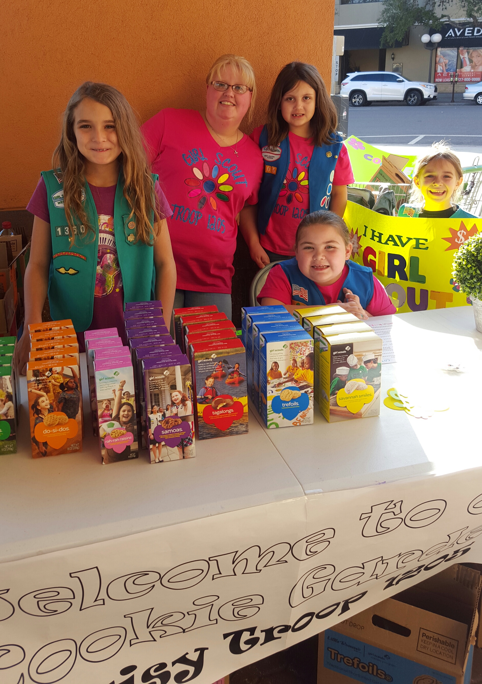 Anna (left, age 9) helped her sister, Kate (right, holding sign, age 6) at her first Girl Scout cookie booth. The troop will use a portion of their sales for community service. Anna's troop has been helping Pack a Sack and Kate's troop has been helping the Ronald McDonald House.