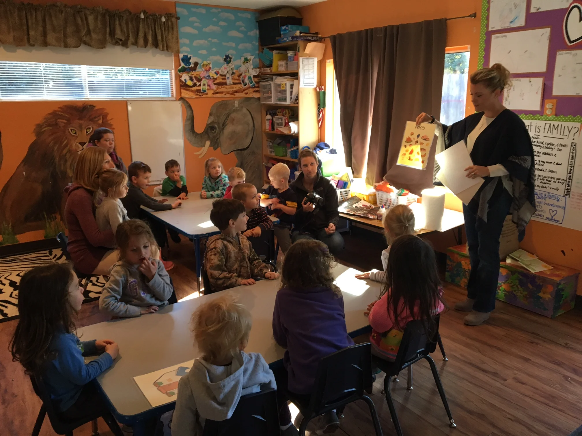 Kelli Plevyak is talking to the students about basic necessities such as a home, food, clothing and a bed to sleep in. 