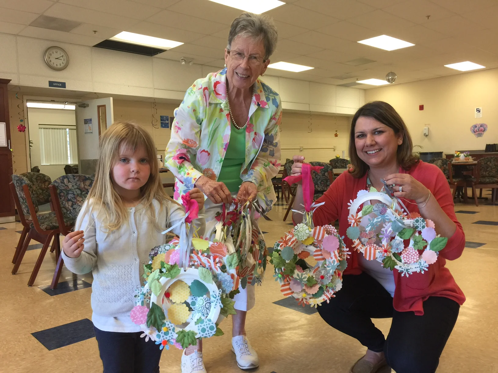 Addie giving the Madrone flower wreaths to Yvonne Griffin (left) and Rebecca Todd (right). They were extremely appreciative and excited to distribute them to the senior members of their center. 