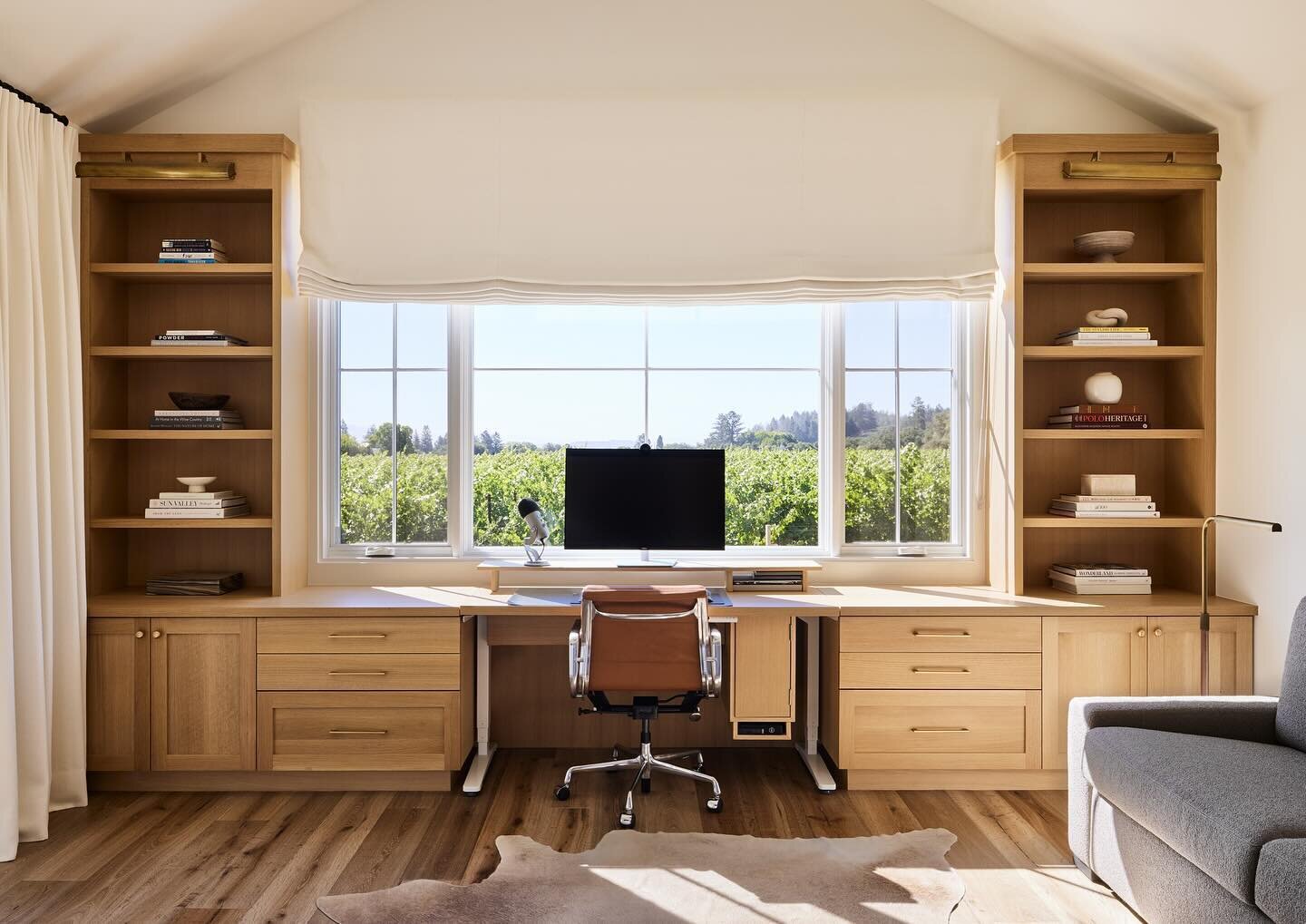 Work with a view 🖊️ This home office, overlooking acres of vineyards was a joy to design.  Functional and specific to the clients needs, we designed a custom center section that raised to standing height.  We also catered to their desire to have thi