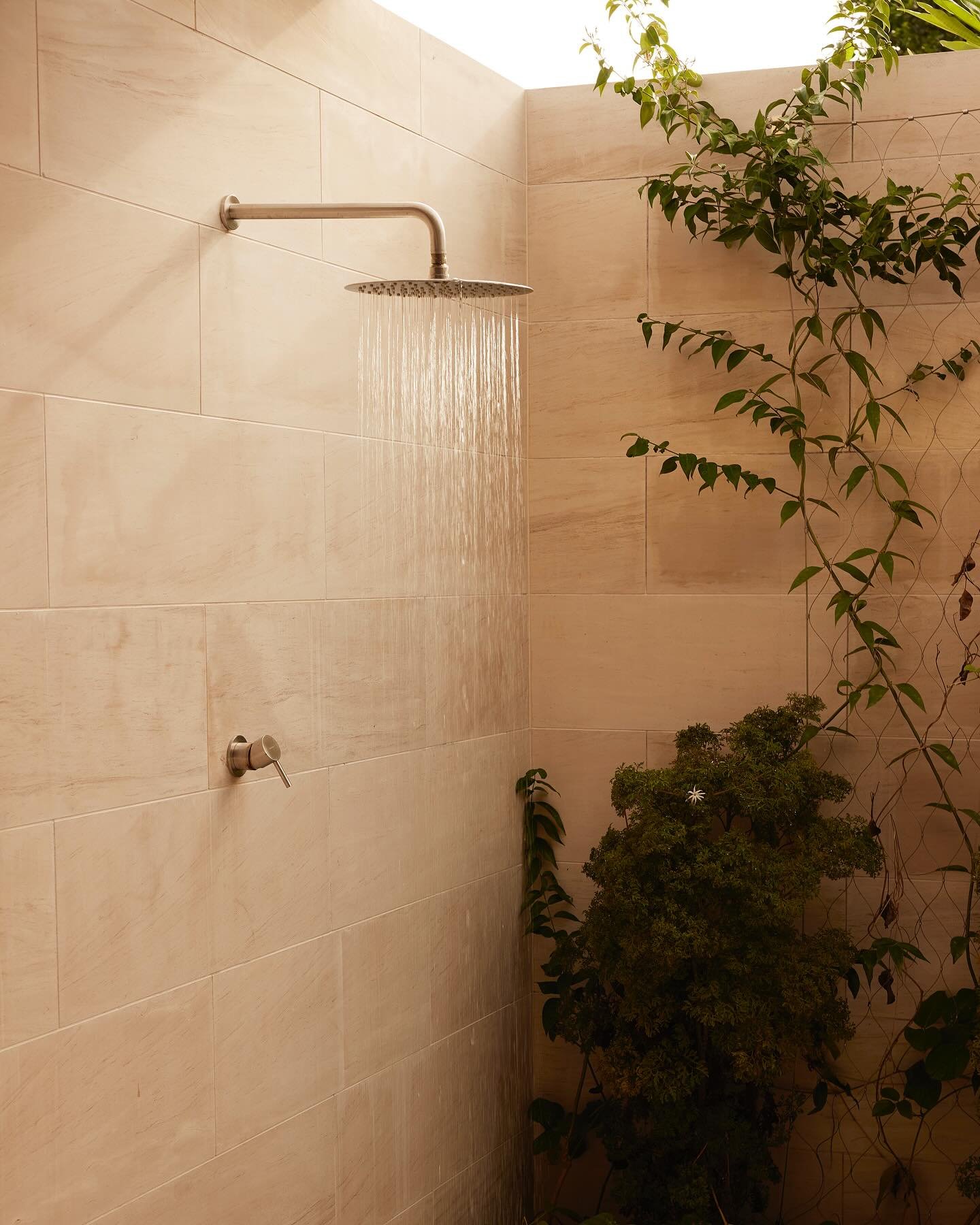 A limestone wrapped outdoor shower in our Fiji project captured by @seanfennessy