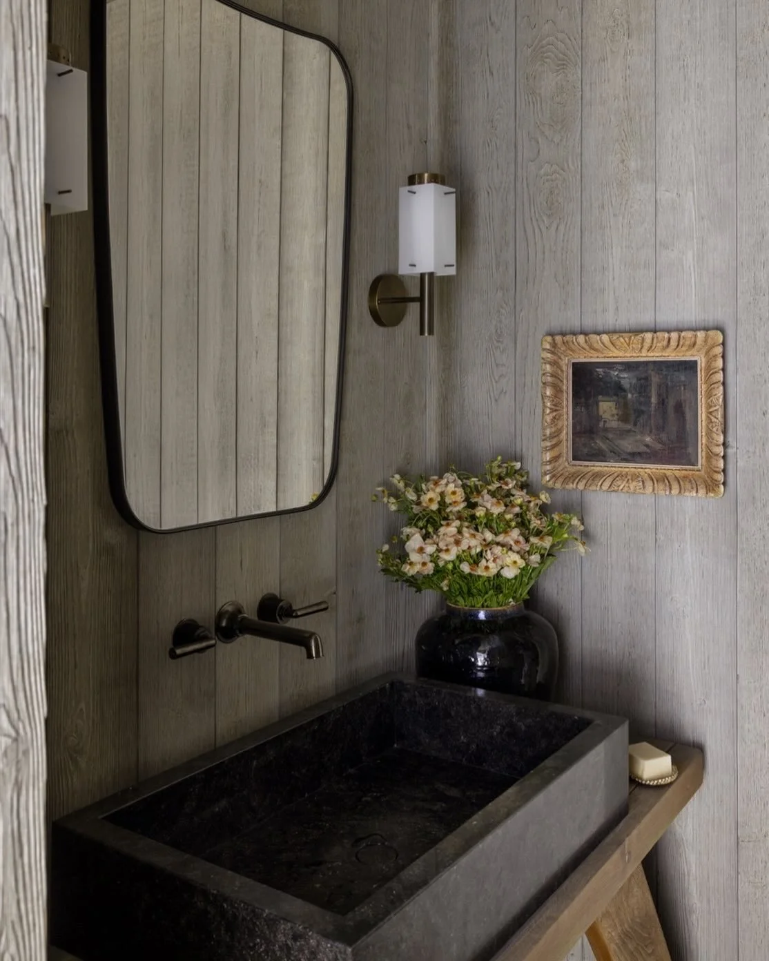 Cedar wrapped walls meet a petit granite sink that rests on an antique table in the powder room at our @rivieradevelopmentcompany Victoria project. 📸 @bessfriday