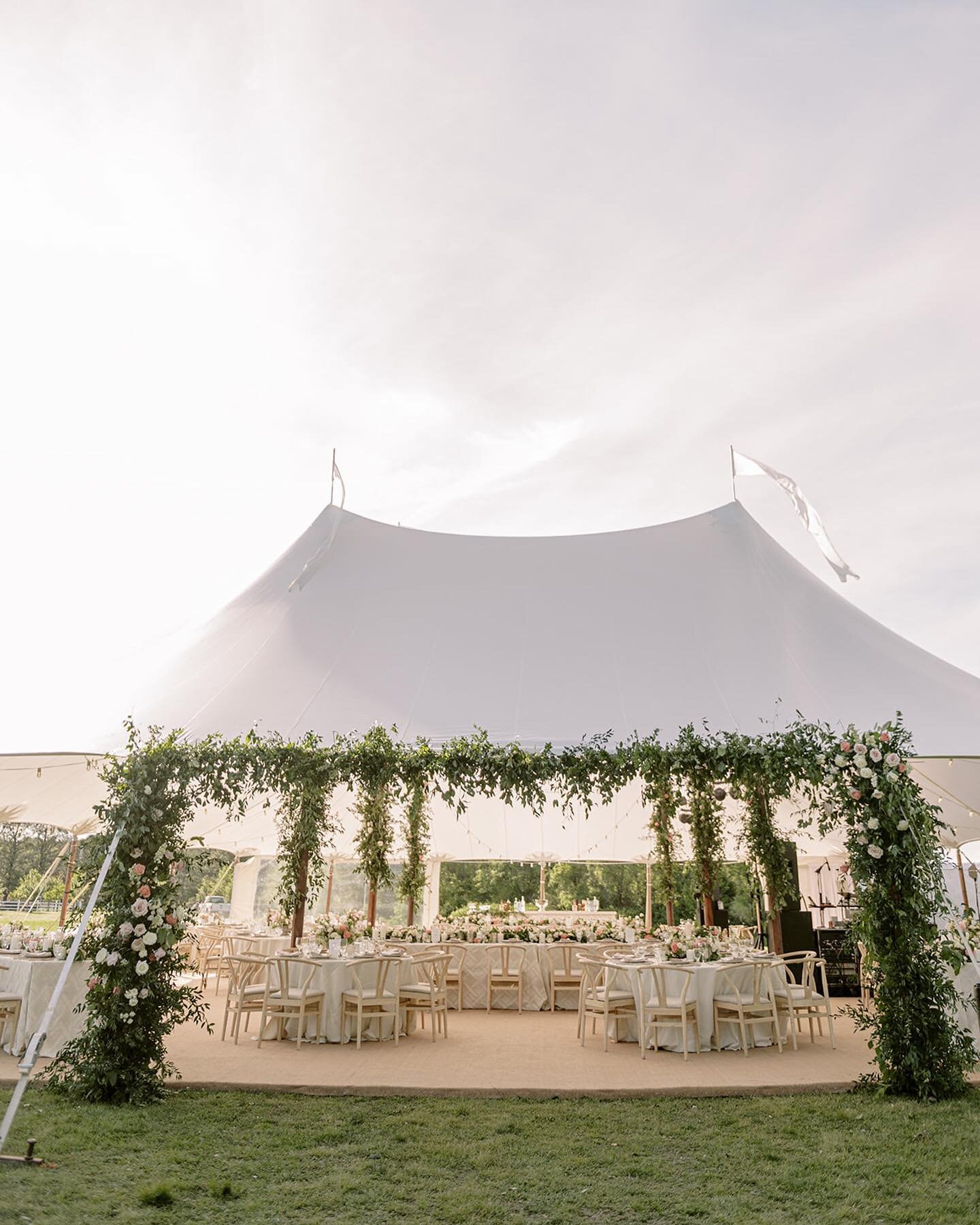 As a floral designer, it's always our dream to design an atmosphere that captures the essence of a couple's love story. Under this sailcloth tent, we had the honor of designing a floral installation that enhanced the whimsical charm that a tented rec