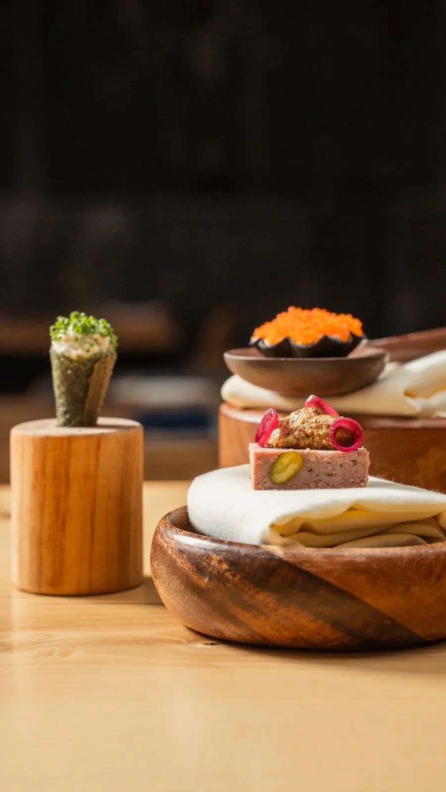 Three small dishes from a multi course prix fixe tasting menu